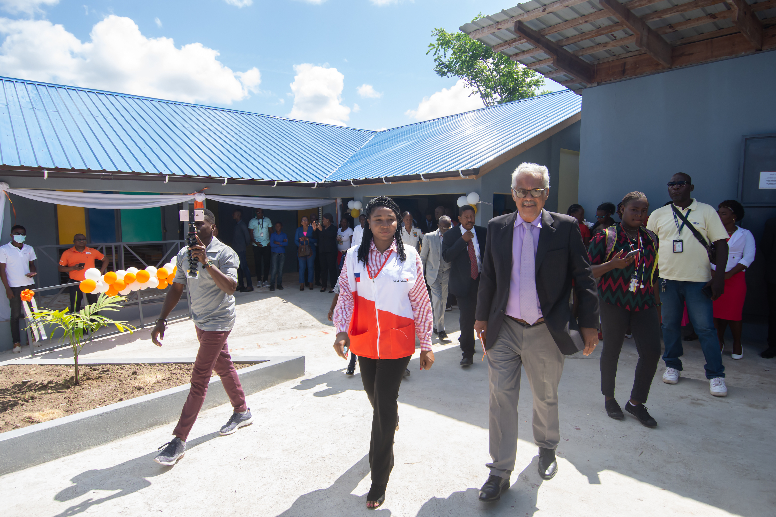 Anne Mosie Dieu, Emergency Response Coordinator takes M. Auguste D'Meza on a tour of the school