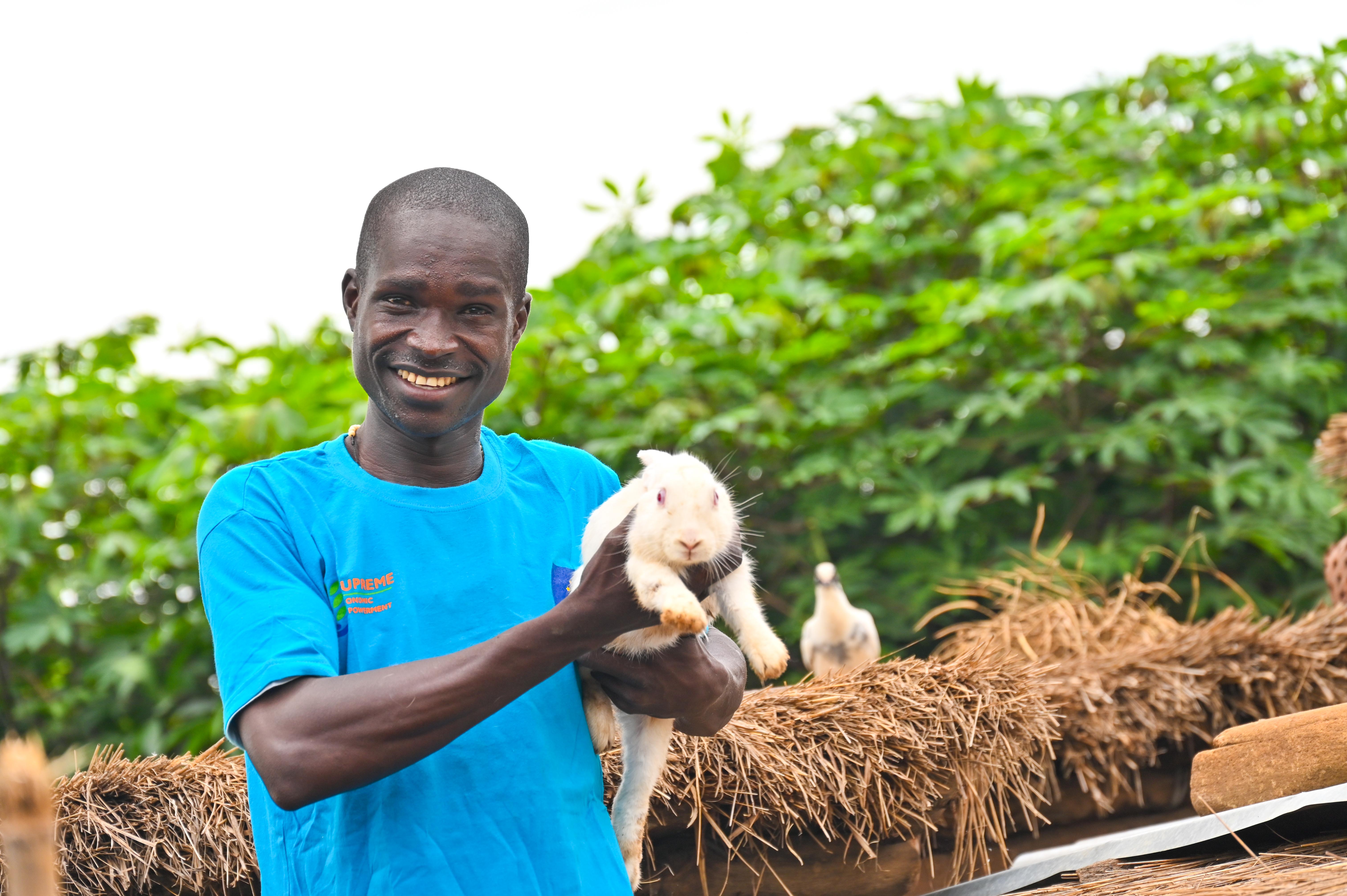 James displays some the rabits in his farm