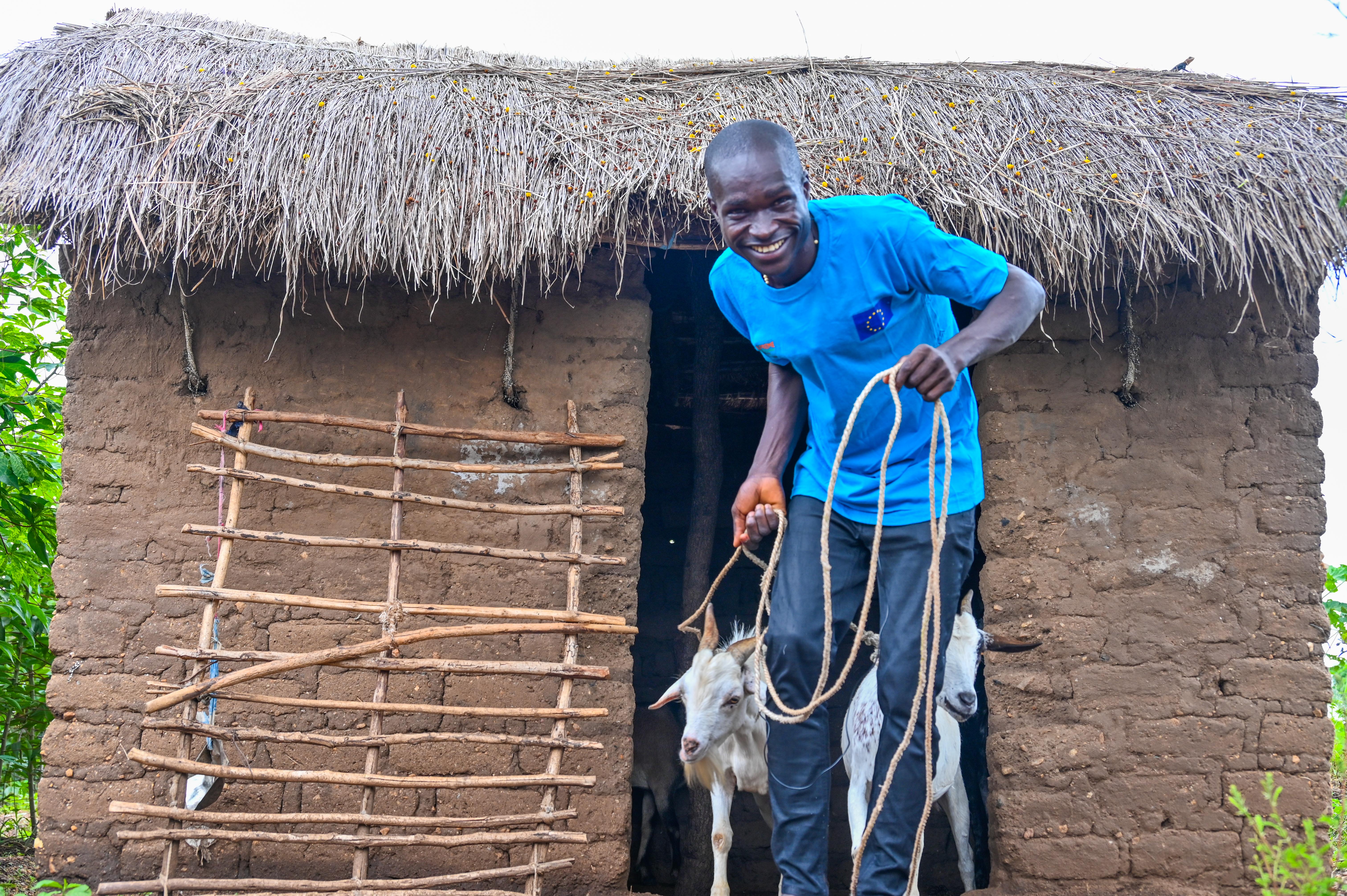 James diligently tending to his farm's goats with care and commitment.