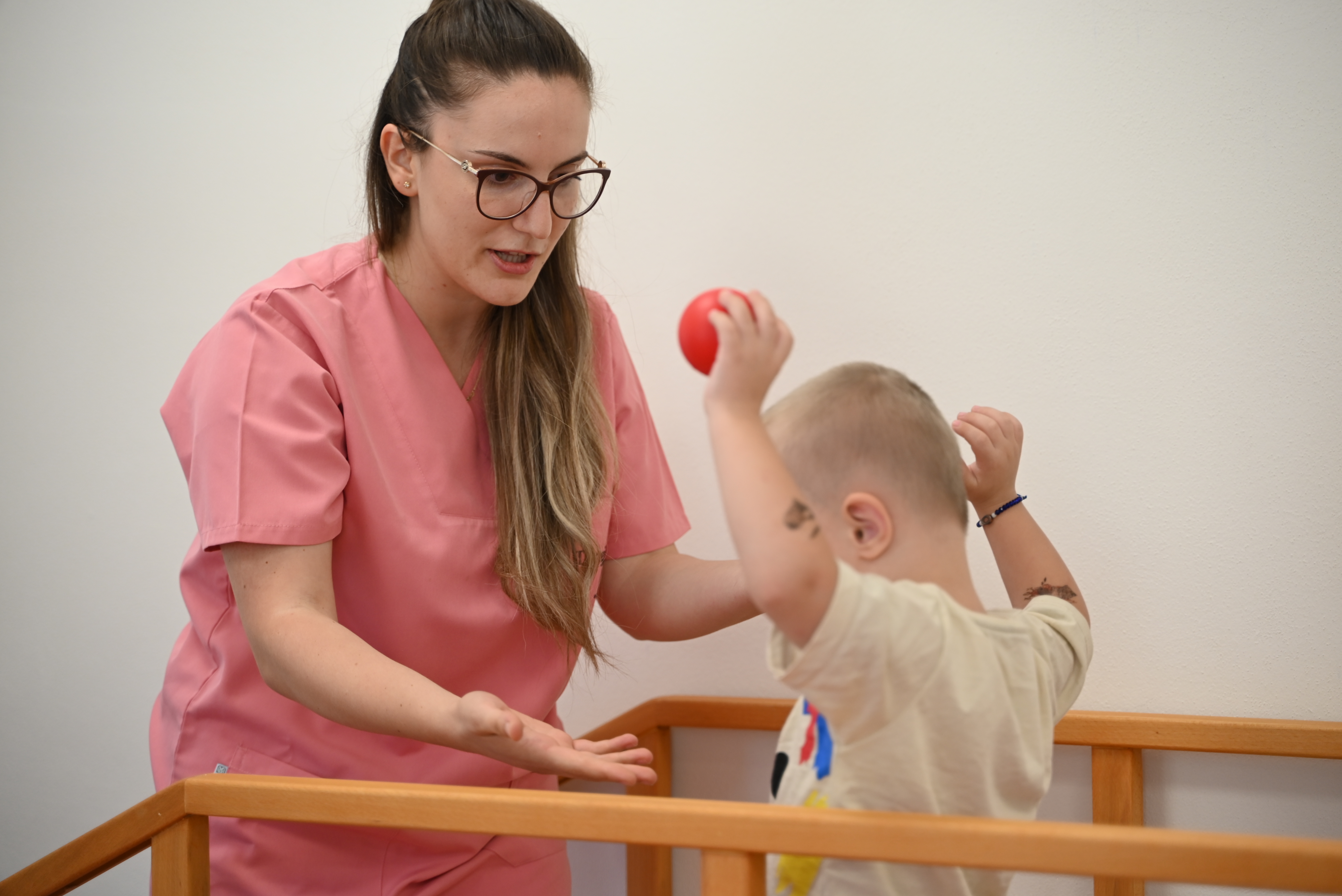 Dorela, during a physiotherapy session, with one of the beneficiary children