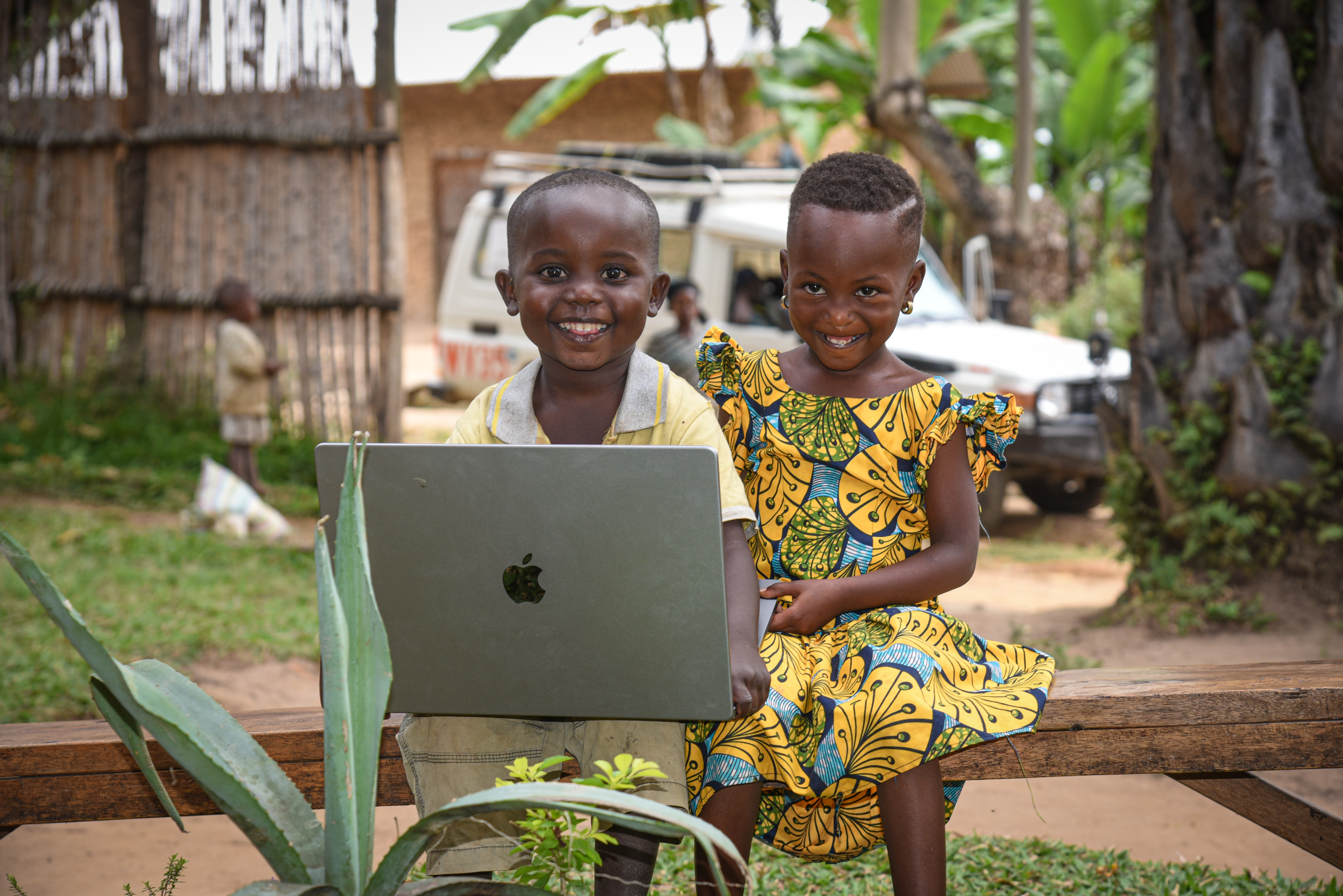 Cartel, 4, and Adriana, 5, play with a laptop while waiting for their mother to finish taking part in a World Vision focus group.
