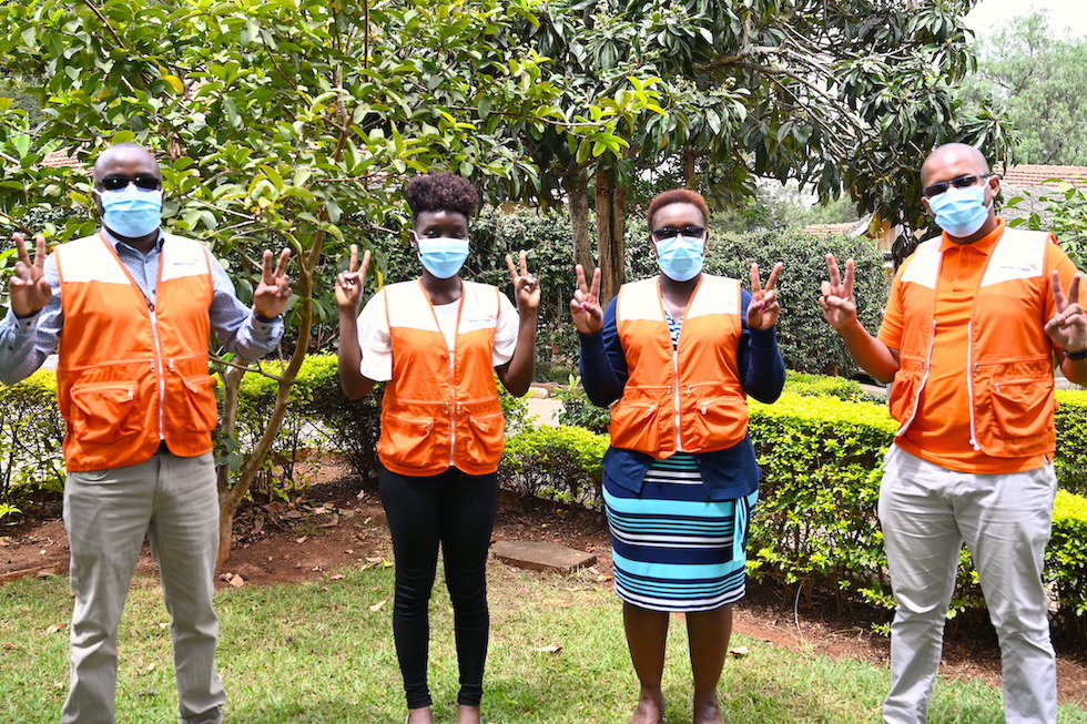 World Vision Kenya staff that have been vaccinated join the 'V - for vaccinated' campaign. Just as many Kenyans who have received the vaccine, they are glad that it will reduce their chances of getting the disease. 
