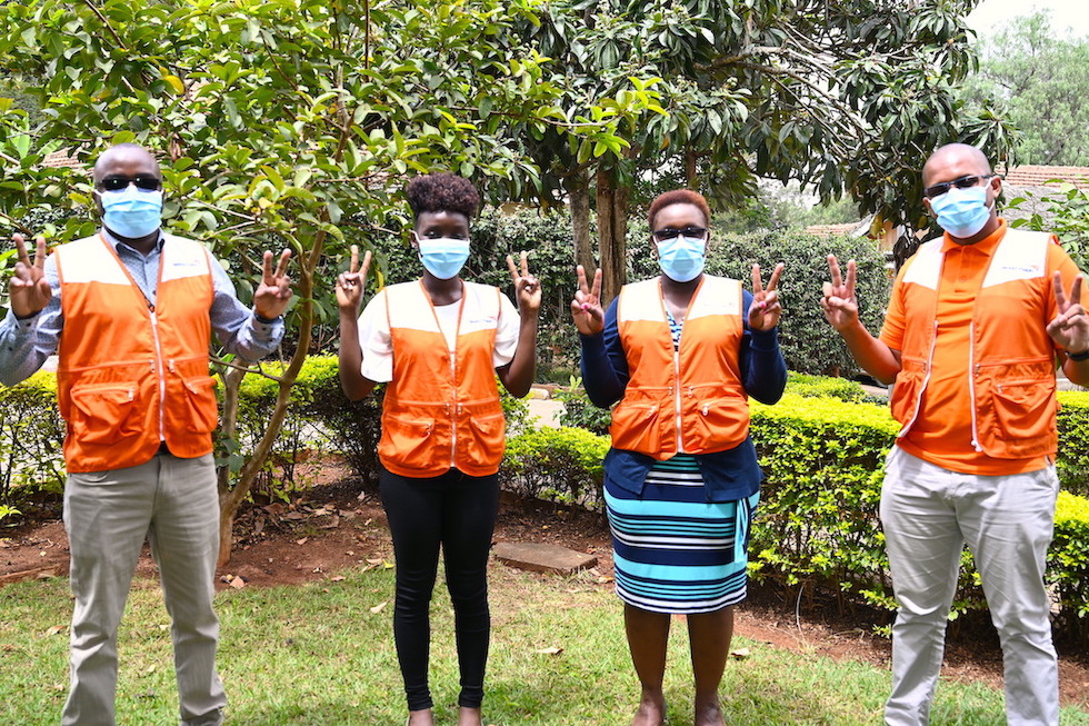World Vision Kenya staff that have been vaccinated join the 'V - for vaccinated' campaign. Just as many Kenyans who have received the vaccine, they are glad that it will reduce their chances of getting the disease.