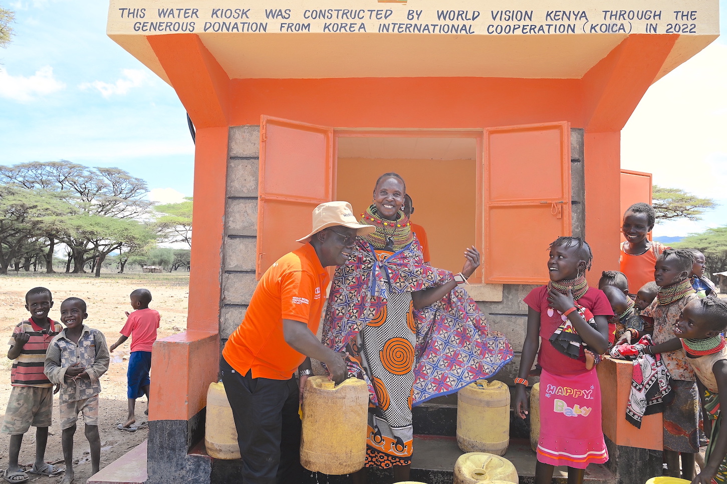 The National Director of World Vision Kenya, Gilbert Kamanga, interacts with women and children at the Daaba Water Project implemented by World Vision in partnership with KOICA. ©World Vision Photo/Sarah Ooko.