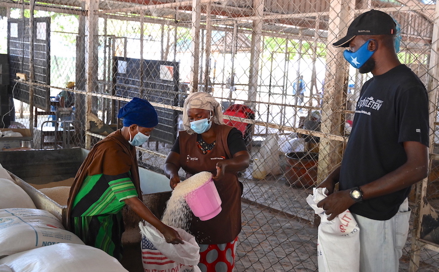 Refugees collecting at one of the distribution centres managed by World Vision and WFP at Kakuma Refugee Camp. Members of staff from both organisations are on standby to offer any assistance required.