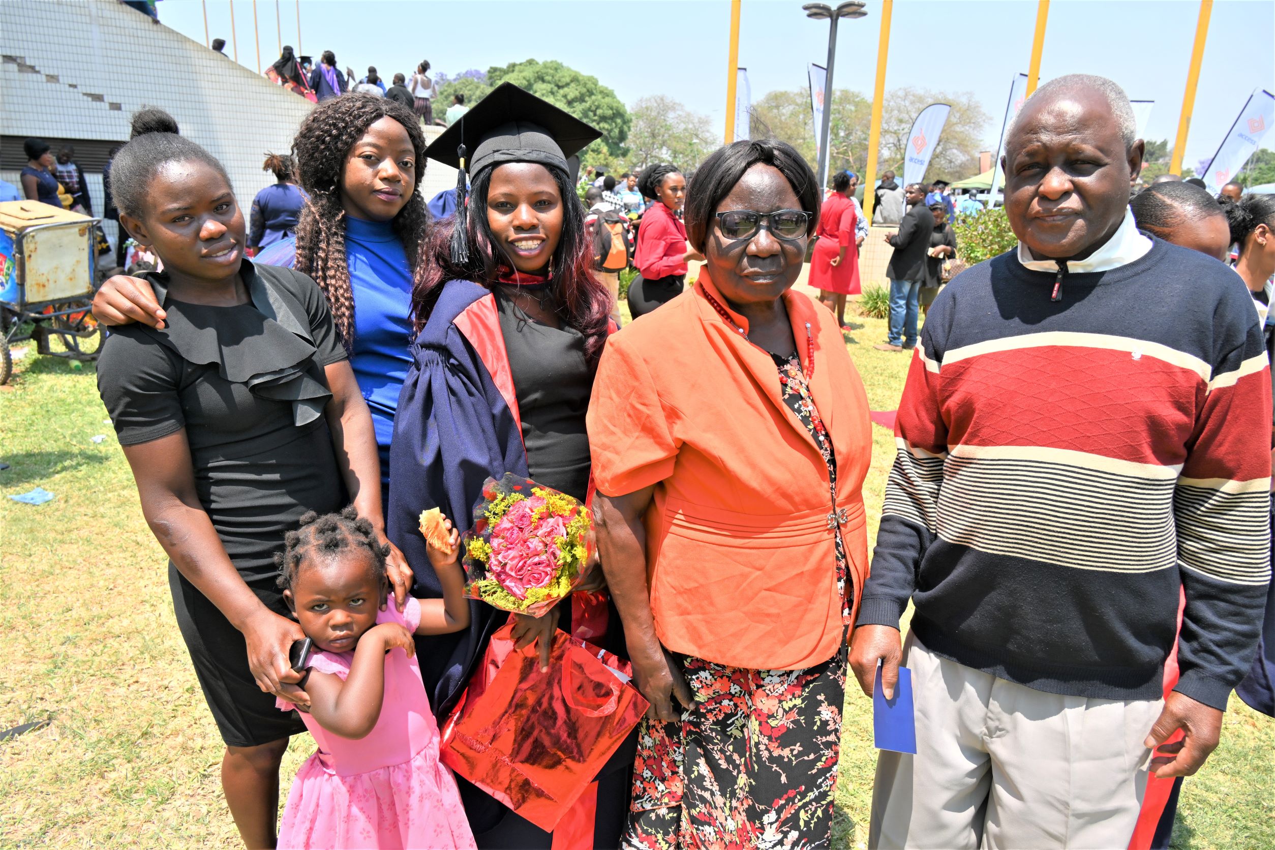 Winfridah with her parents and relatives during the graduation ceremony