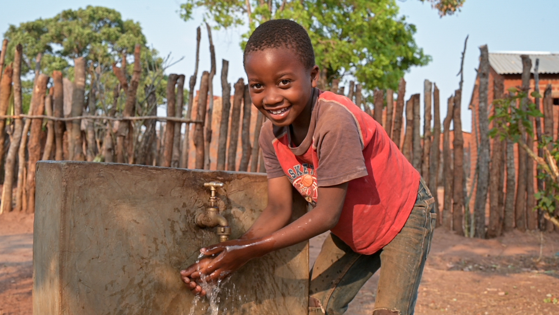 A child washing hands at the water point