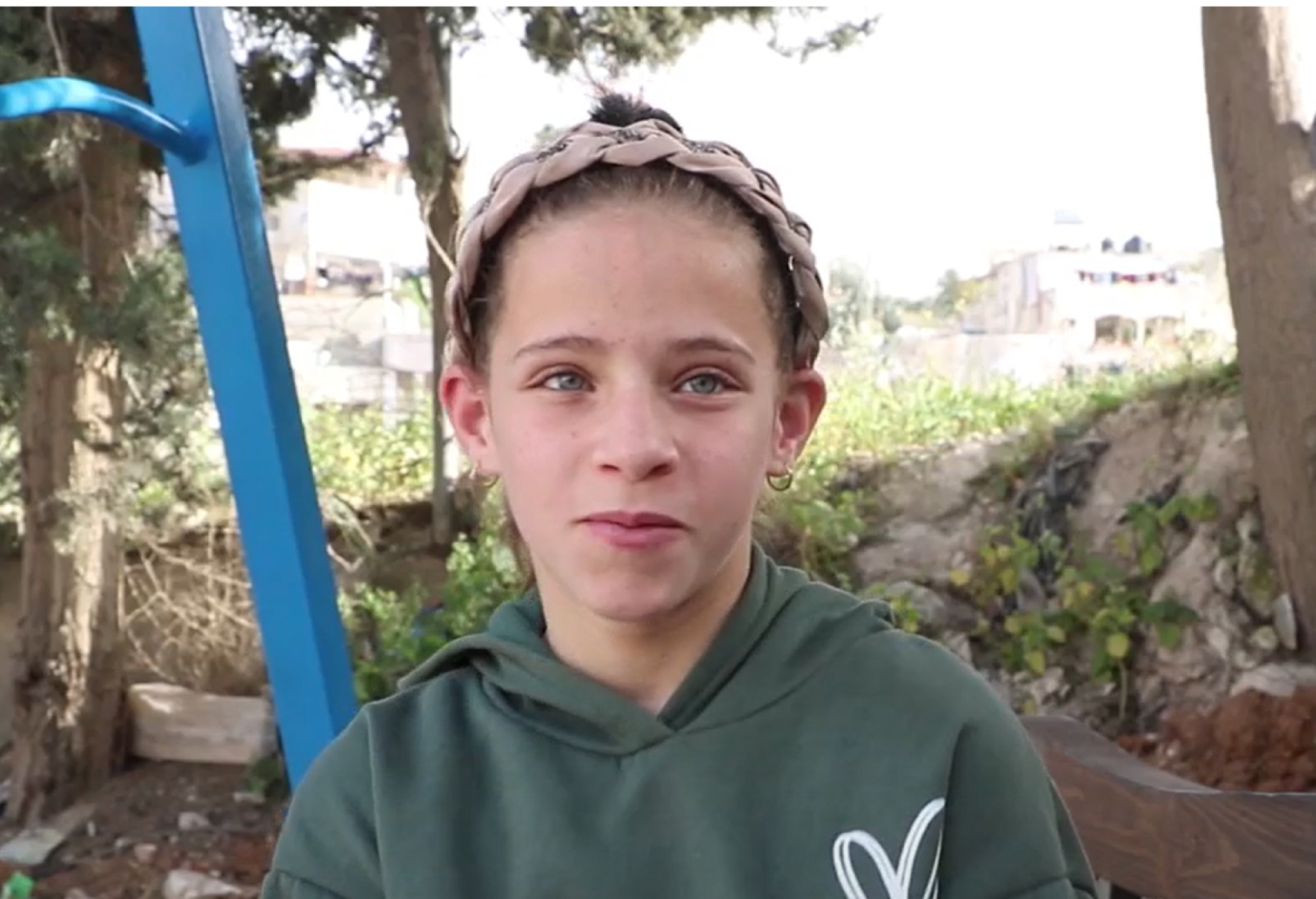 Dalal, a 12 year-old girl, gazes into the camera.