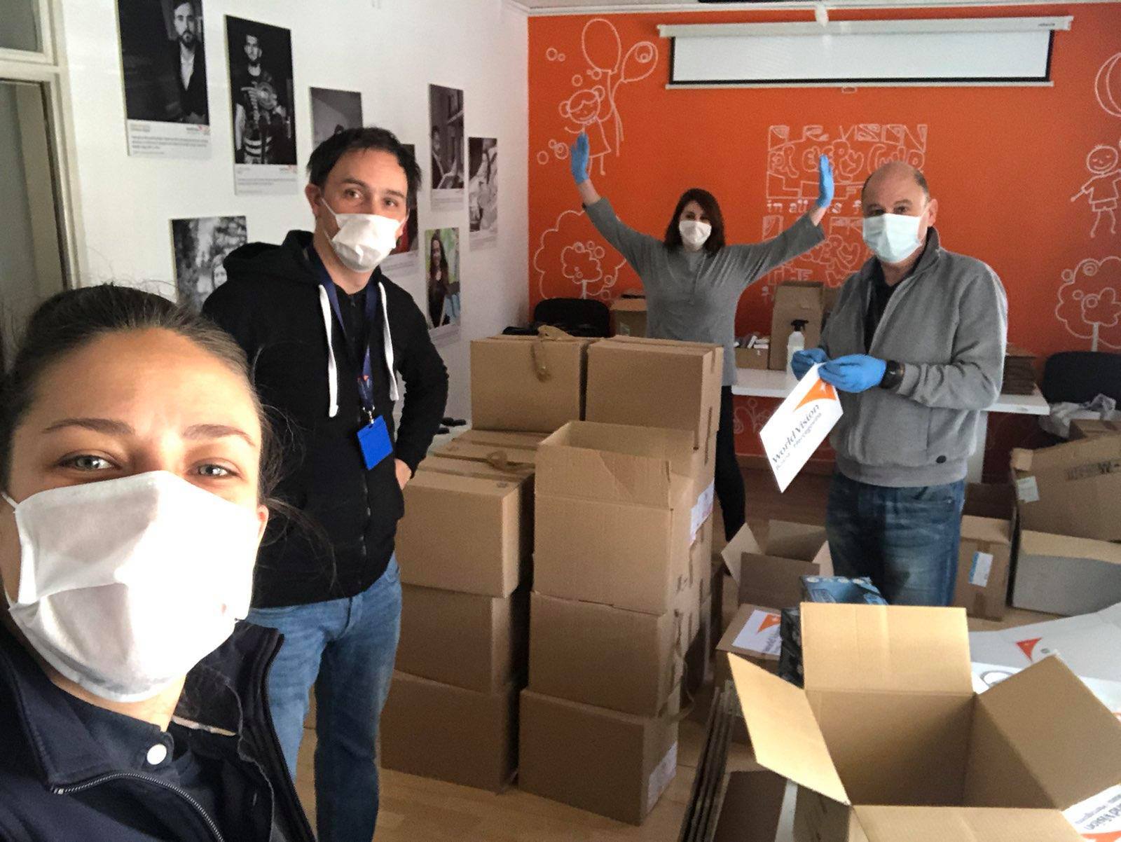 Darko Arsenovski, World Vision BiH Security Officer in the centre, team selfie while packing H&H items