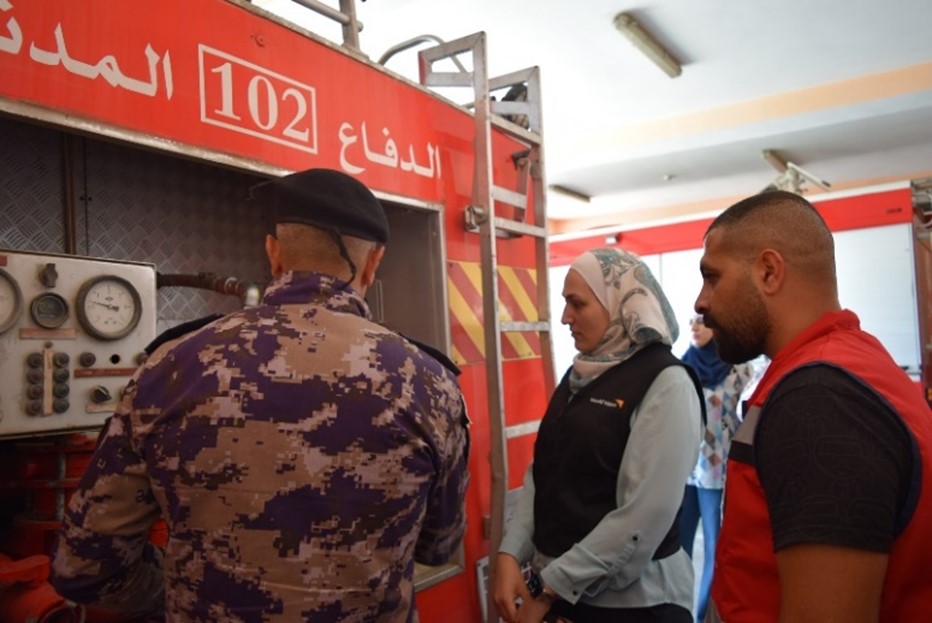 Palestinian Civil Defence staff and volunteer showing World Vision staff old equipment 