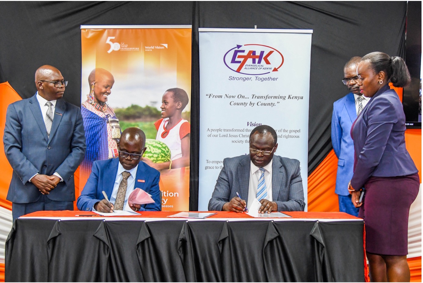 World Vision Kenya's National Director, Gilbert Kamanga (left), and EAK Board Vice-Chairperson, Dr. Robert Langat (right), sign a Memorandum of Understanding at World Vision Kenya headquarters. © World Vision Photo | Samuel Kisambe