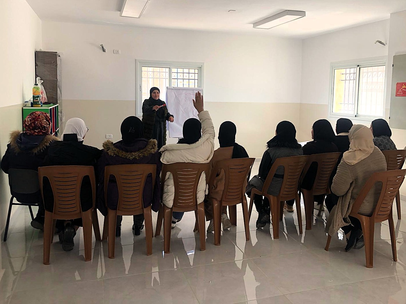 Asala facilitating a session to inform mothers about how to best take care of their new-borns.
