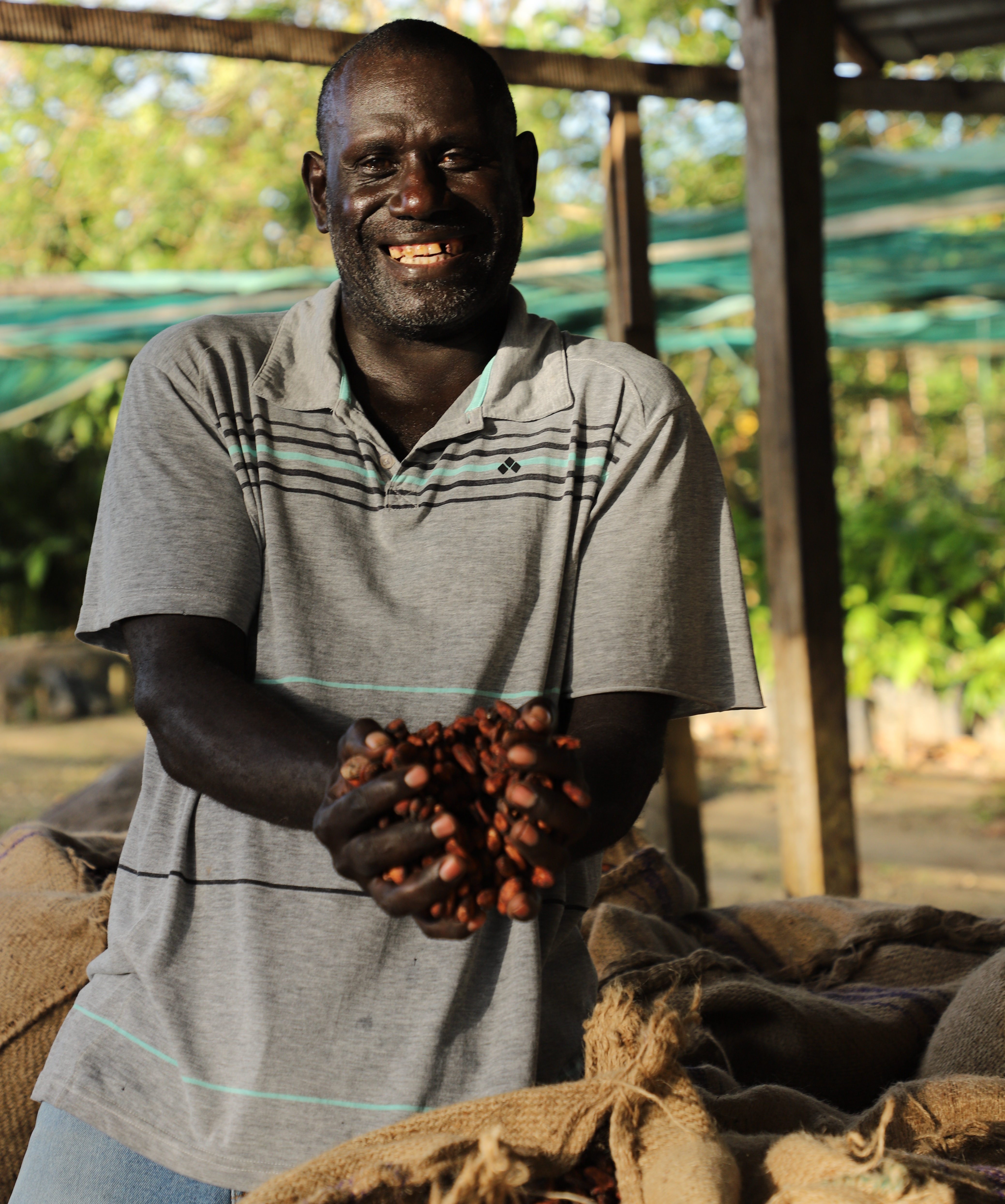 Edward standing with his cocoa bags