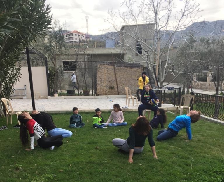 Elise and her family practising Yoga