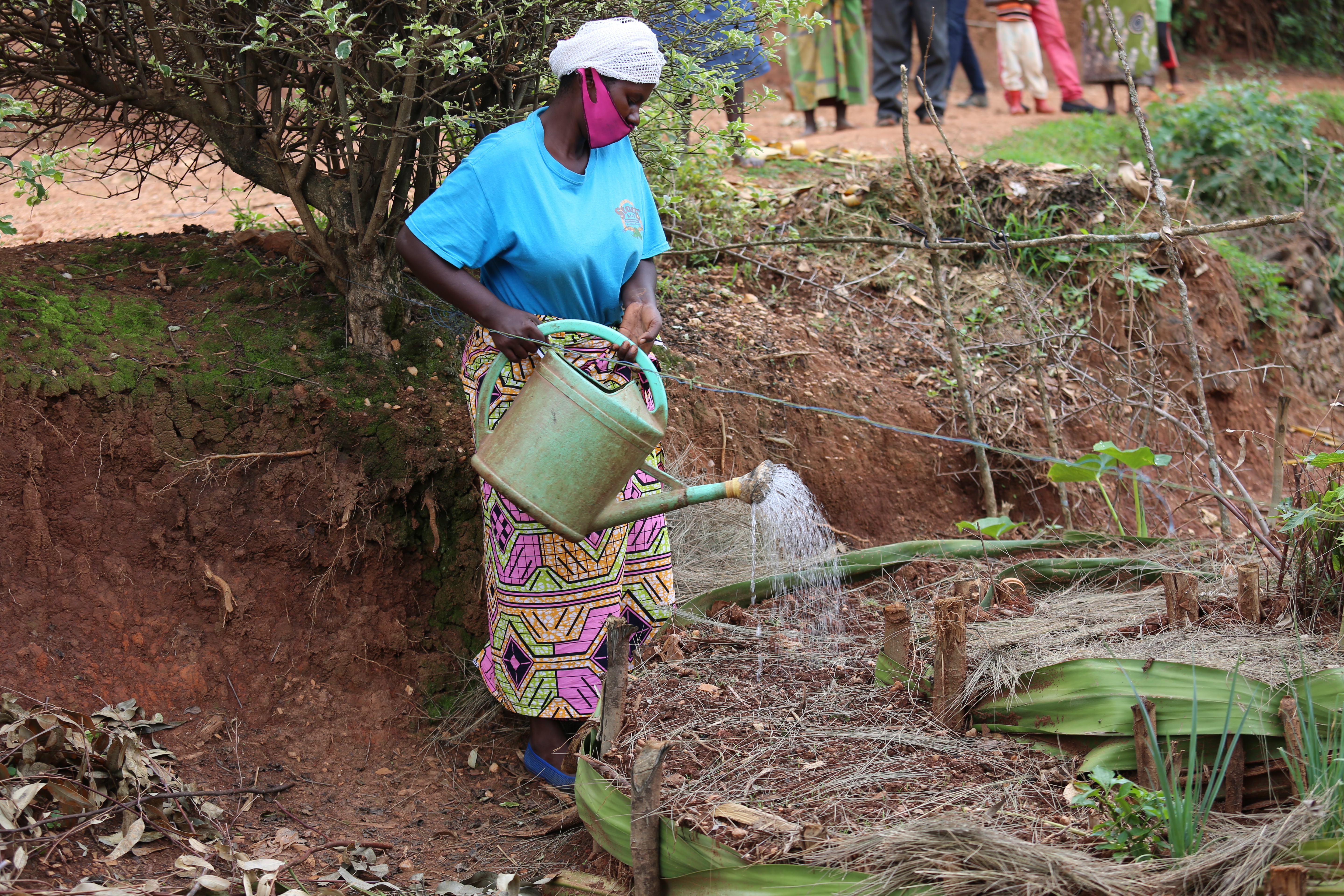 Elizabeth watering her vegetable garden