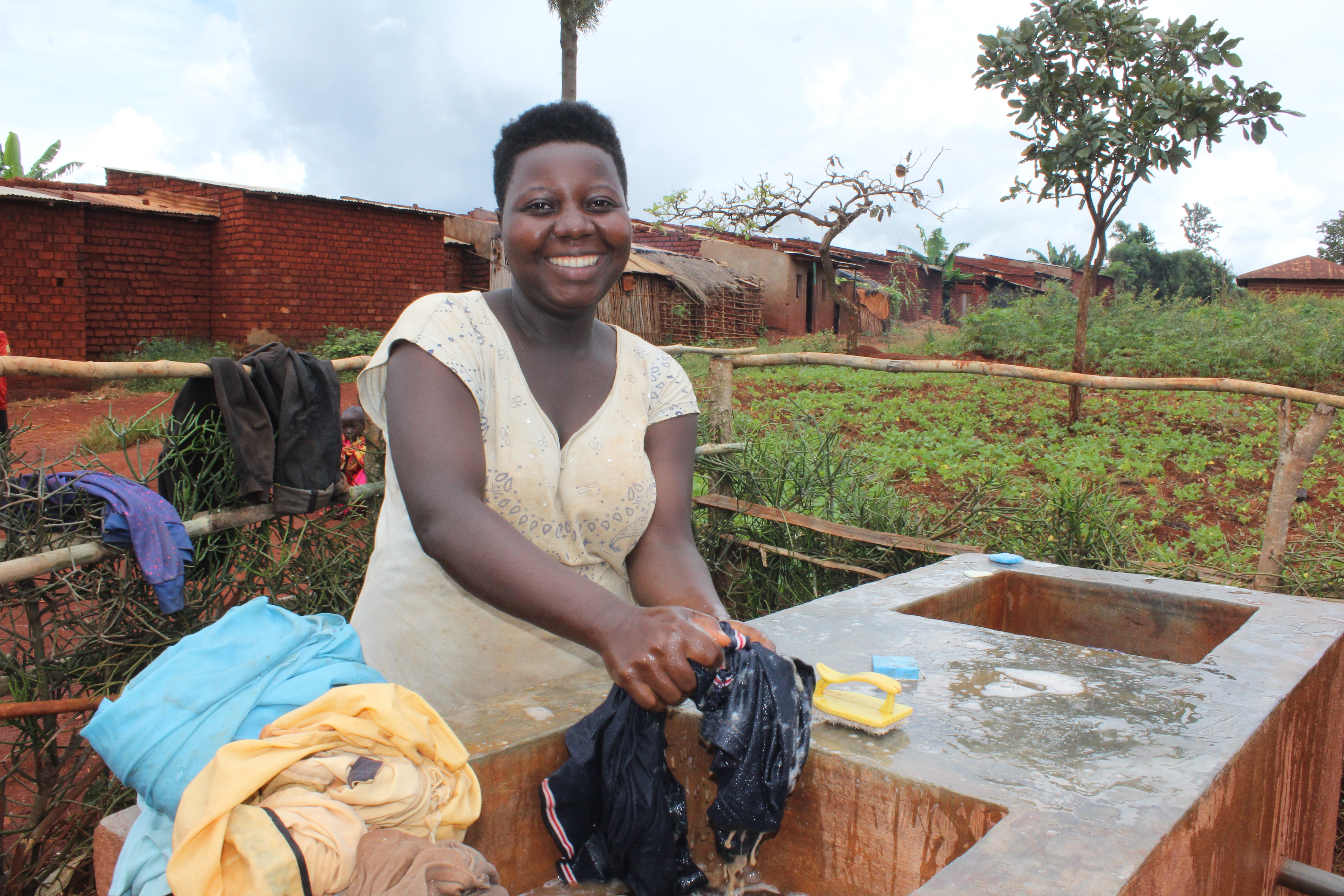 Kabanga community members enjoy drawing water and washing clothes near their homes