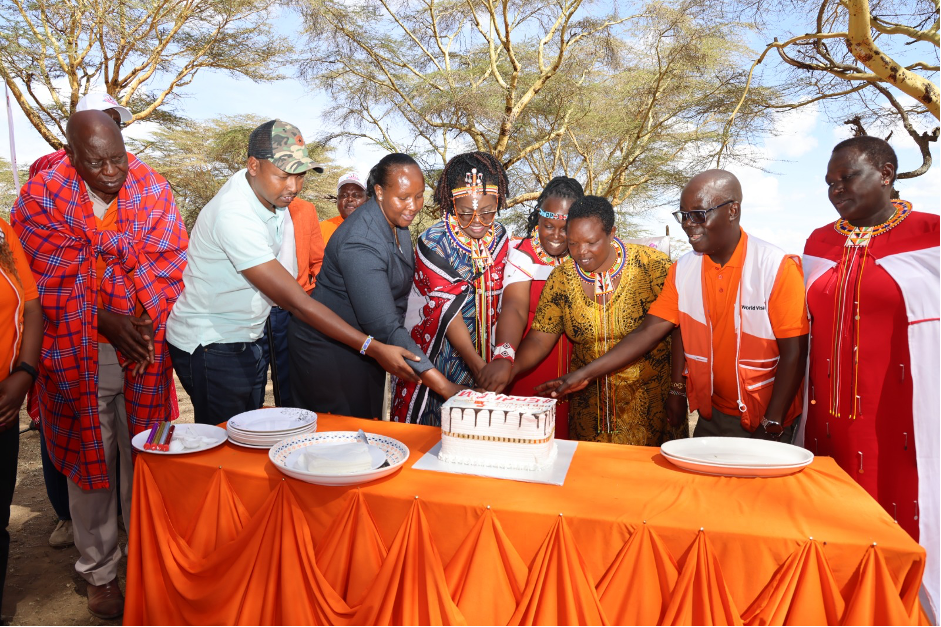 Principal Secretary, State Department of Gender, Hon. Anne Wang’ombe, World Vision Kenya National Director, Gilbert Kamanga, and Anti-FGM Board Chairperson, Ipato Surum cut a cake to commemorate the second Elders meeting against FGM on 1st February 2024. Looking on are elders from the Samburu, Migori, West Pokot, Baringo & Sabaoti communities. 