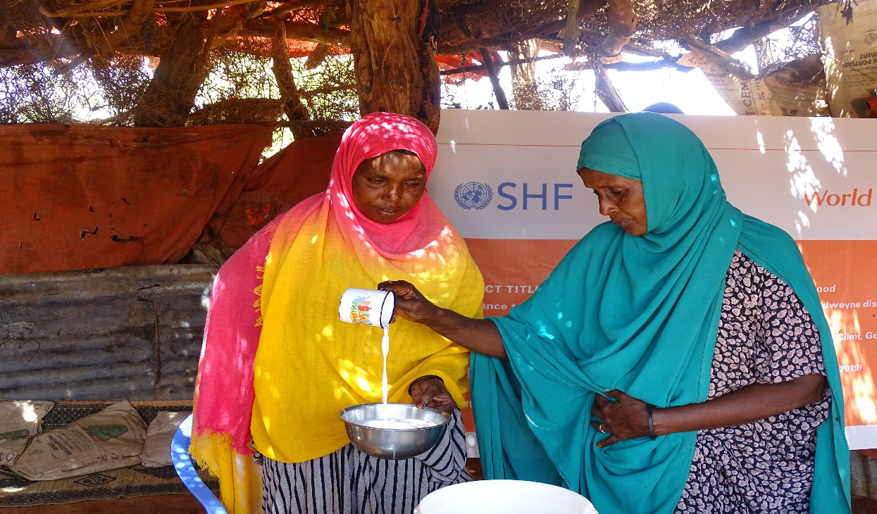 Fatima selling milk to one of her customers 