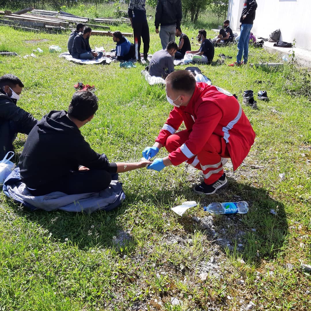 Volunteer feris is providing first aid to the persons on the move.