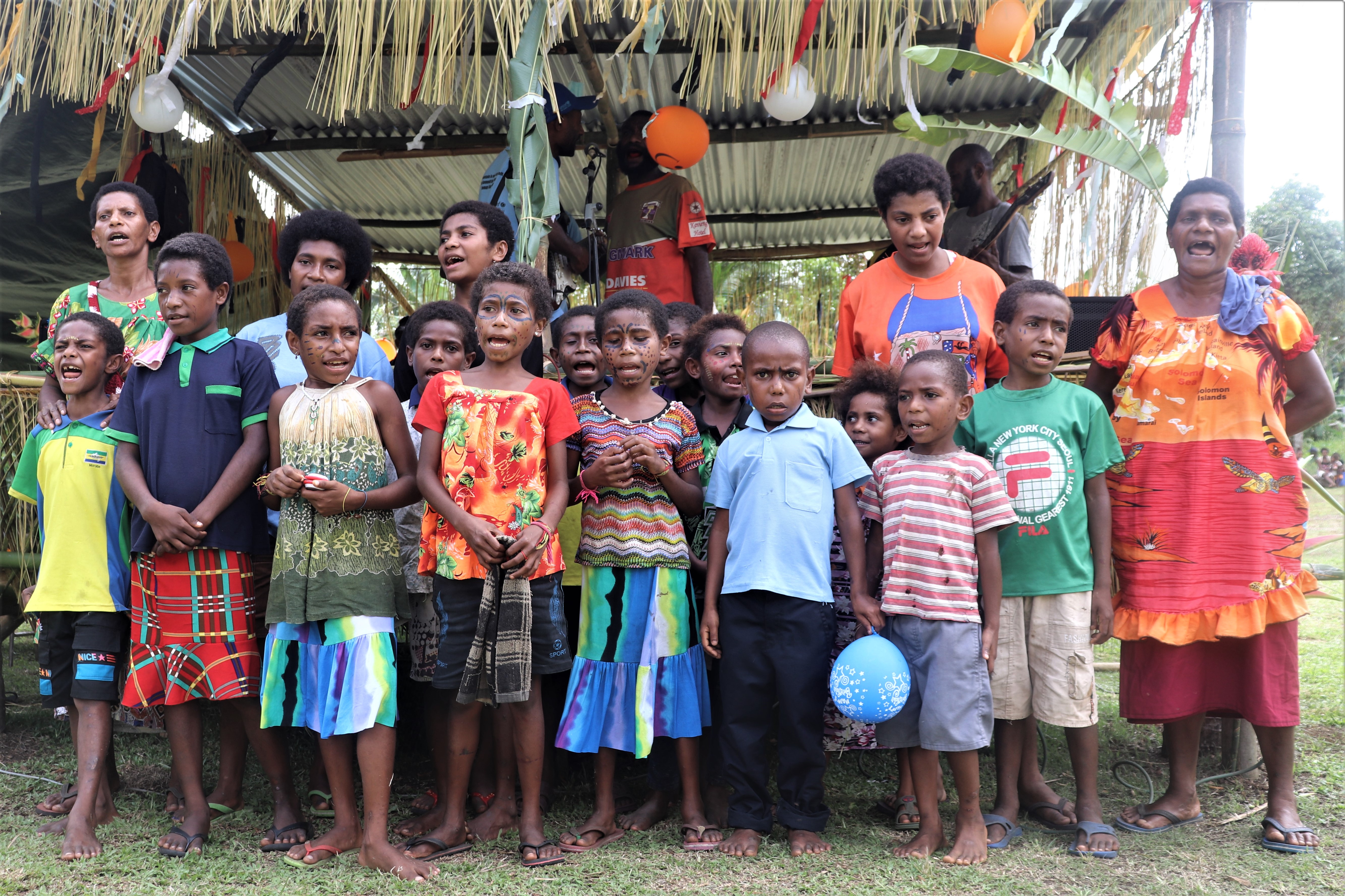 Mothers and Children singing a composed ODF declaration song during their community ODF certification ceremony.