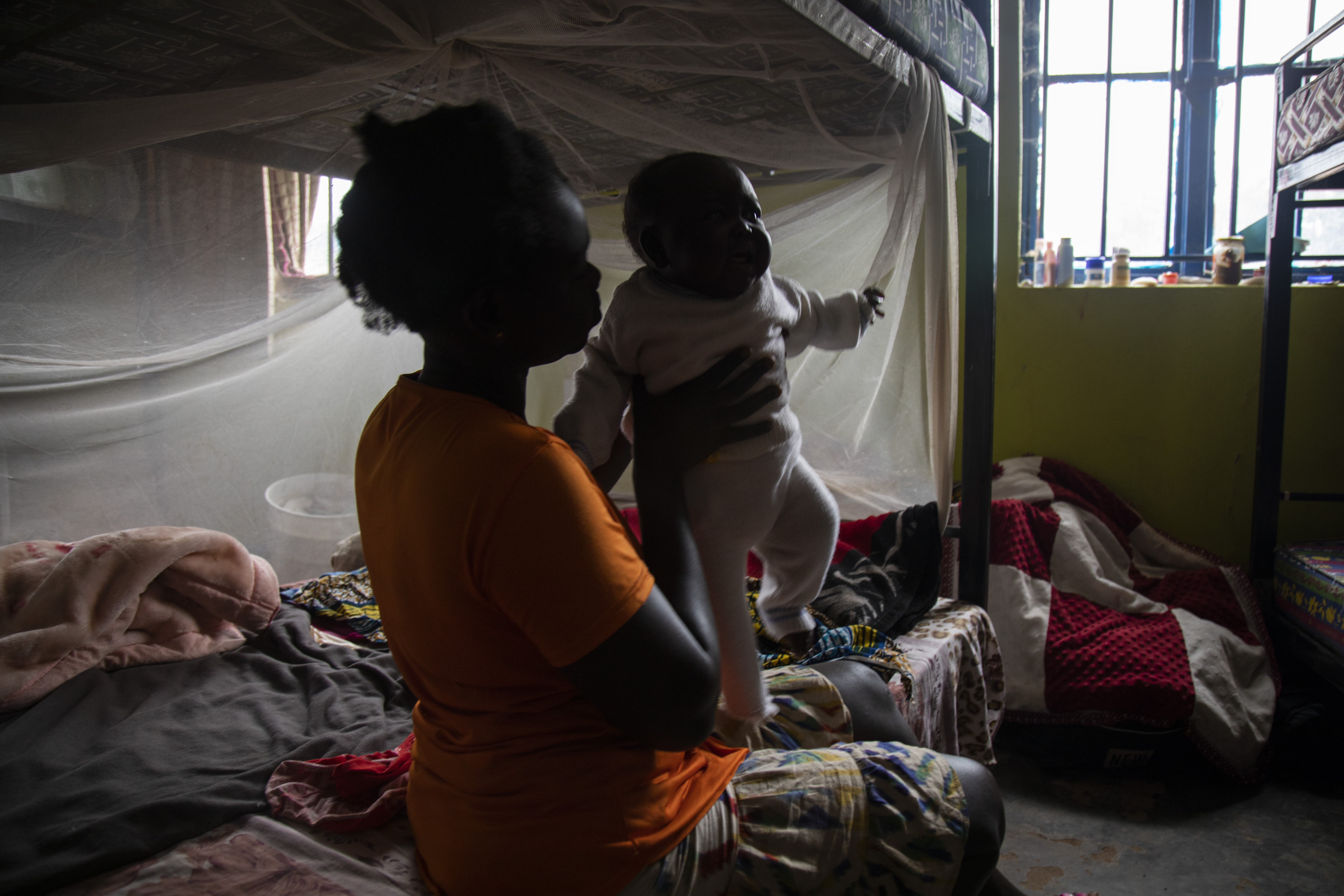 girl sitting with her baby in the dark