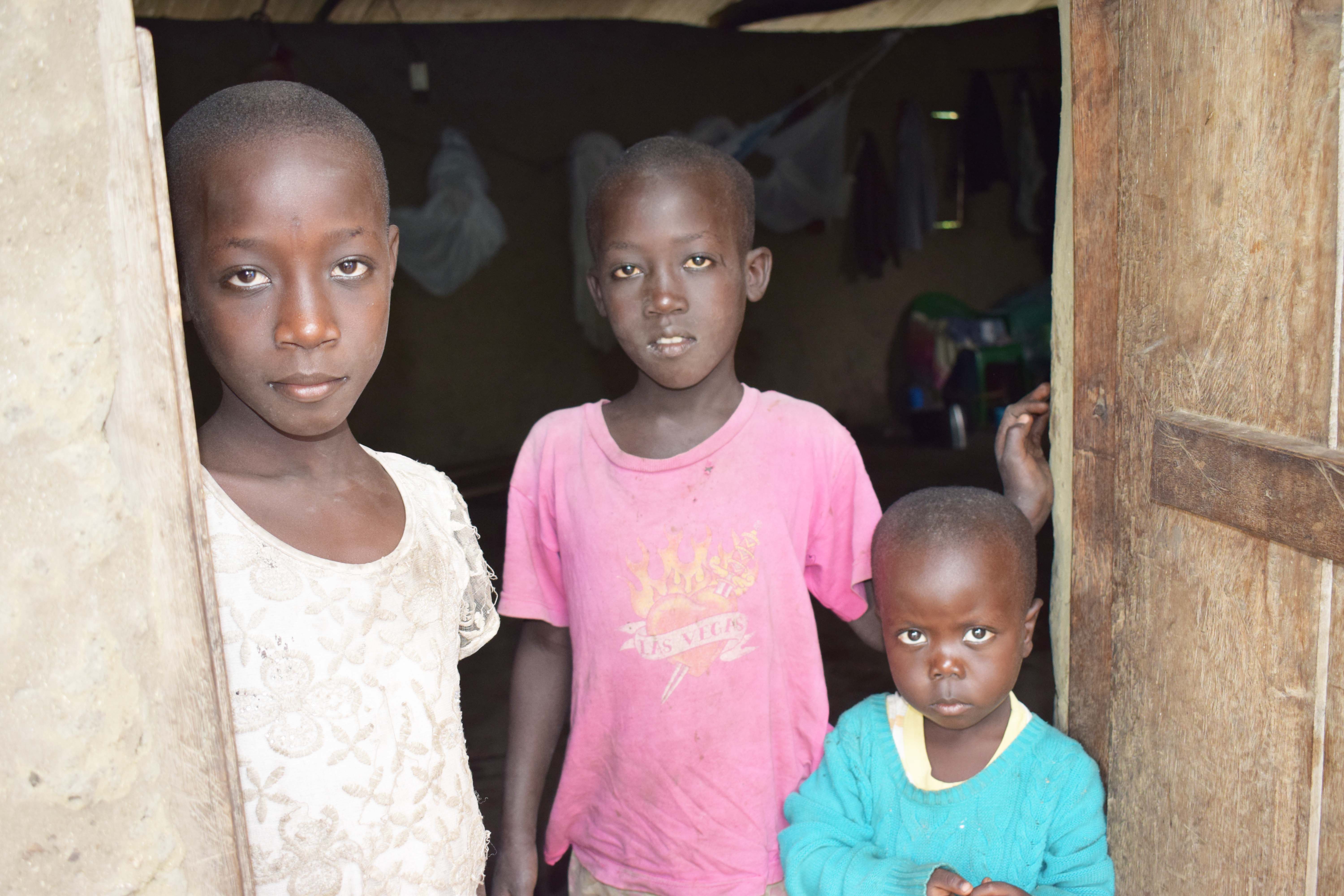 From Left to right Honest,8, Ian,10 and Courage, 3, standing at the door way of the church which has been their home since May. copy