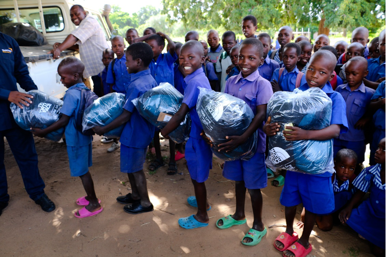 Children line up to receive their sleeping bags