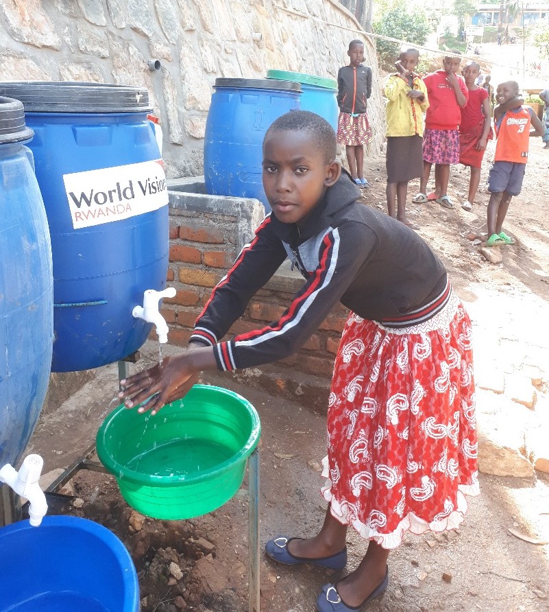 Gael washing her hands at a refugee camp