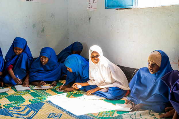 Girls in blue hijabs learning