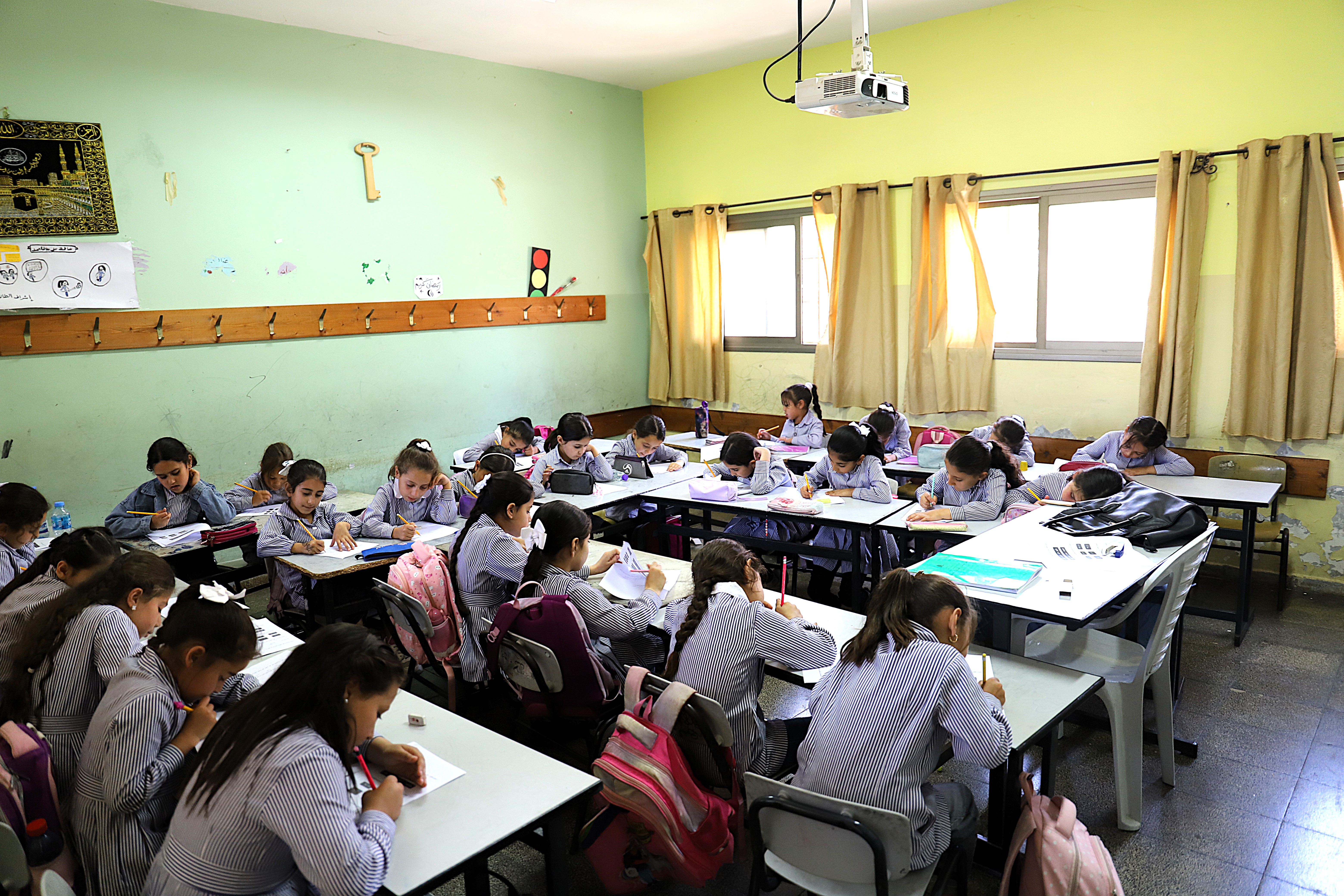 Picture 3: Students studying during a catch-up class in Aneen village – due to the arrival of many new students recently displaced from Jenin, additional tables and chairs had to be installed in the classroom