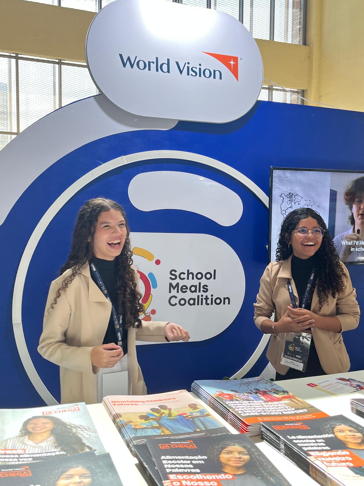 World Vision Brazil Child Advocates Giselle, left, and Dávila, sharing World Vision's child-led research at World Vision's booth in the Marketplace area of the Summit. 