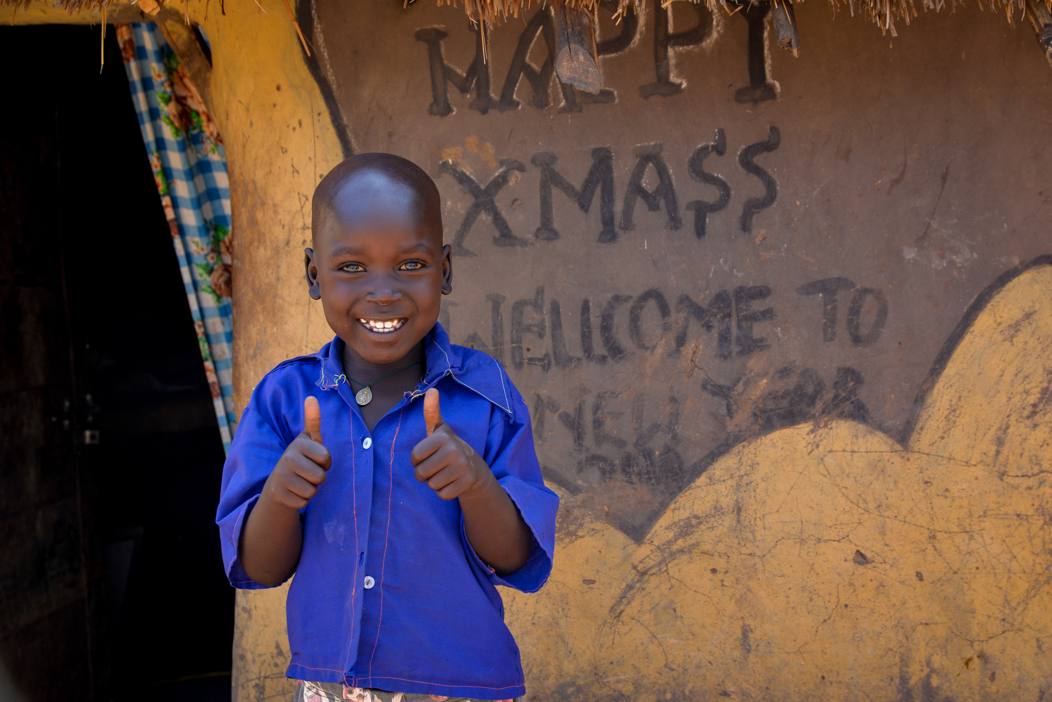 Houses in the settlement get painted and decorated with christmas messages.jpg