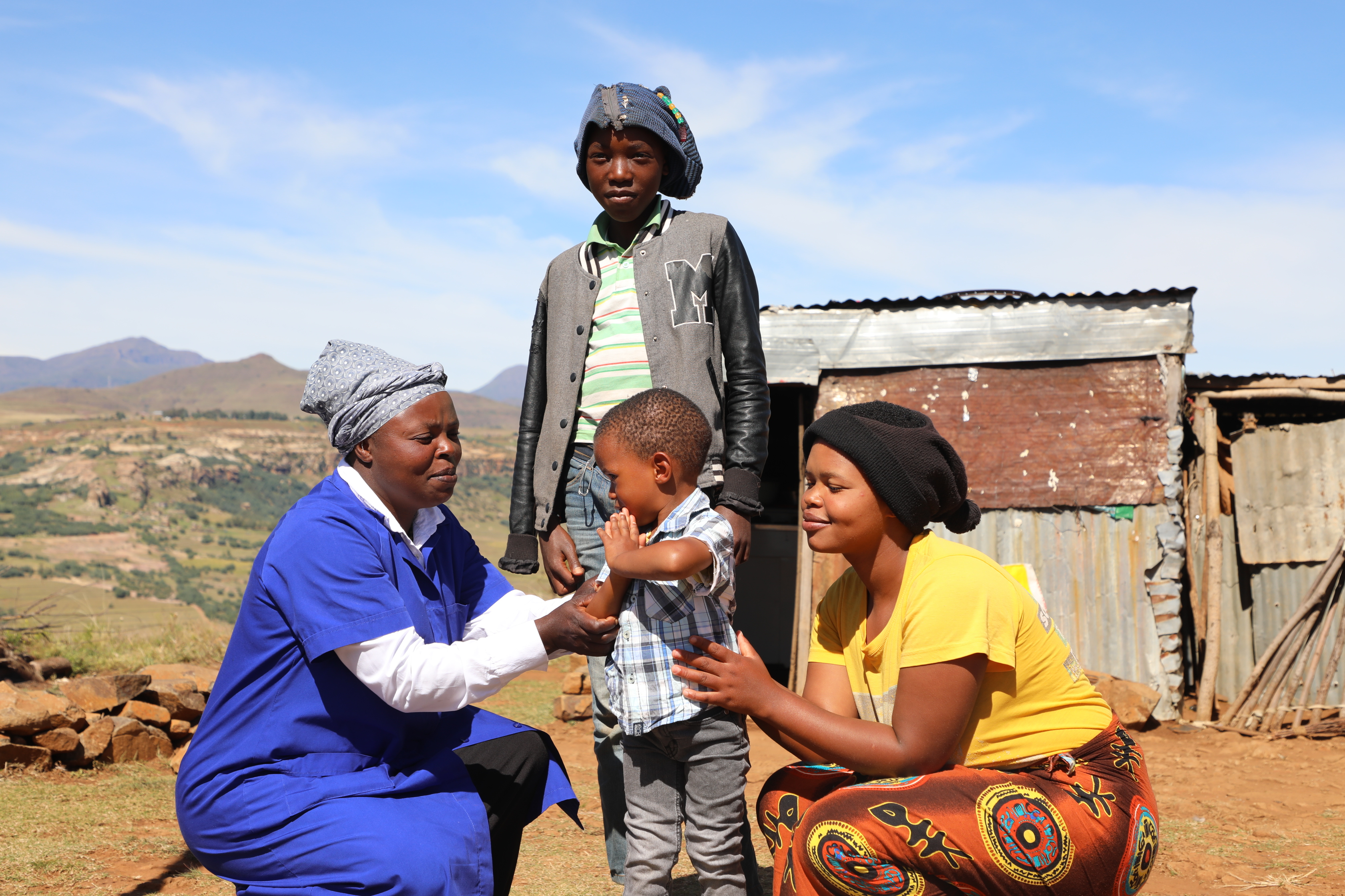 Thato Mohlakola with her children outside their home