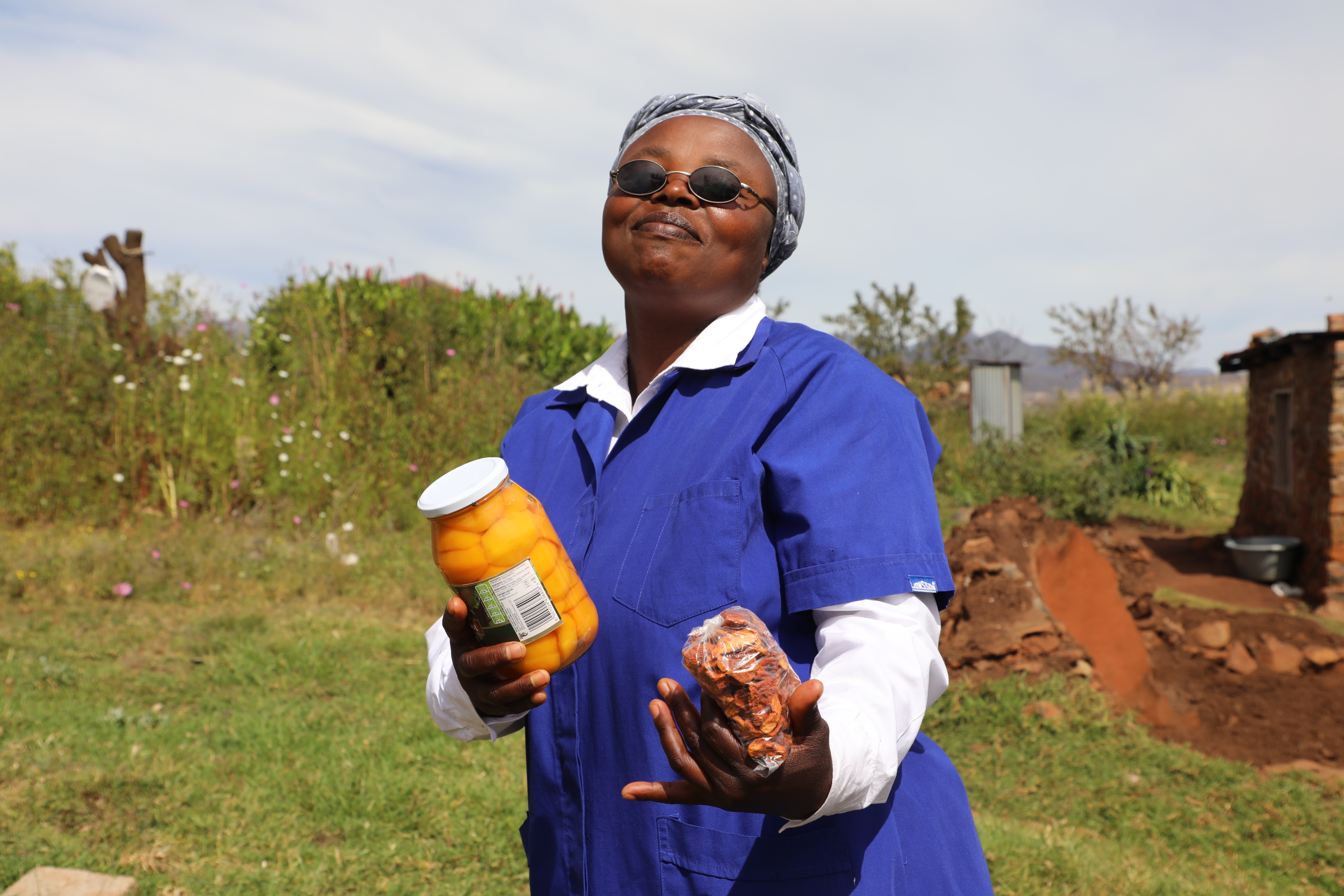 Thato Mohlakola showcases her preserved food which she sells to generate income 