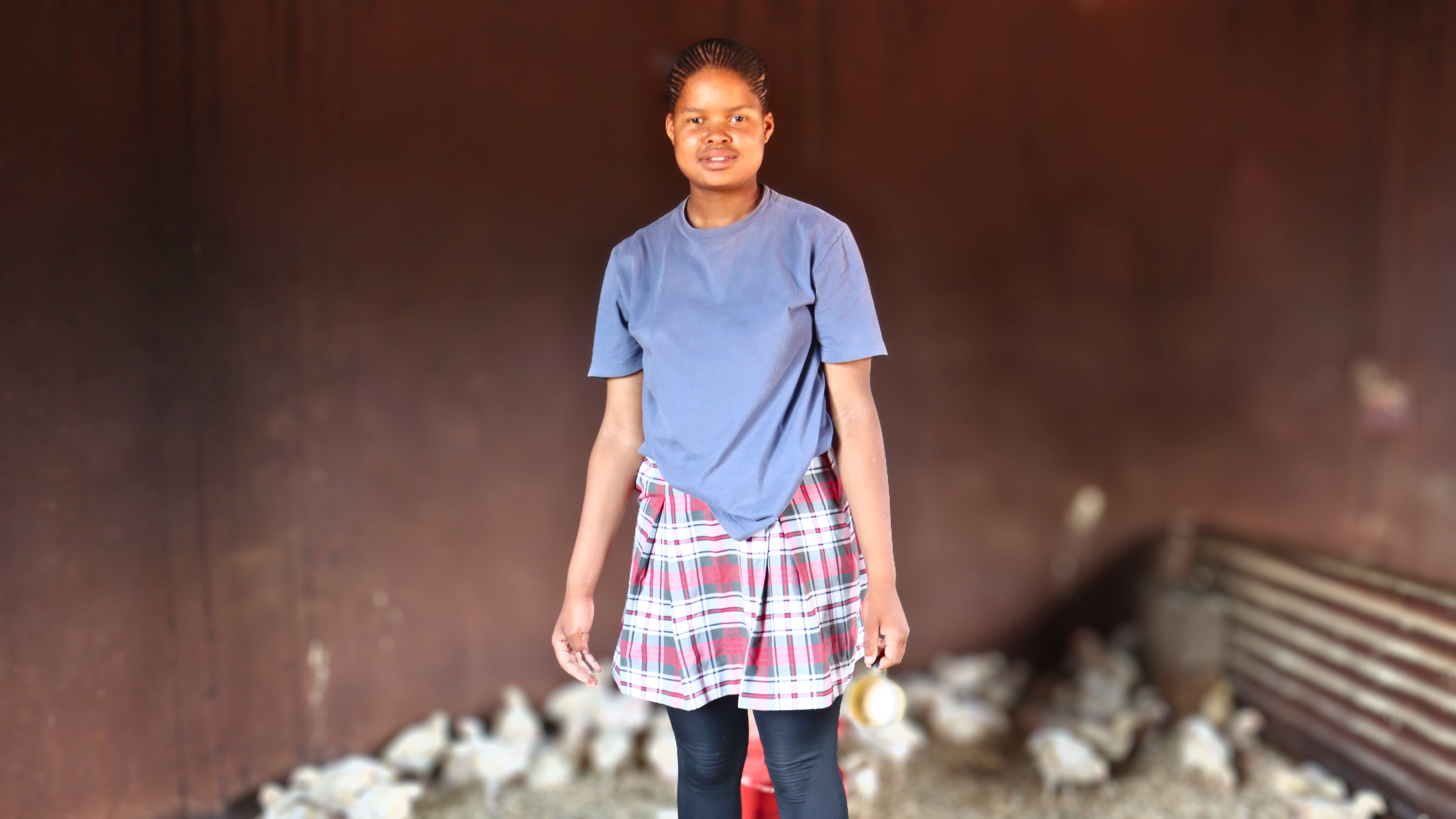 Sibonelo inside her family's chicken coop.