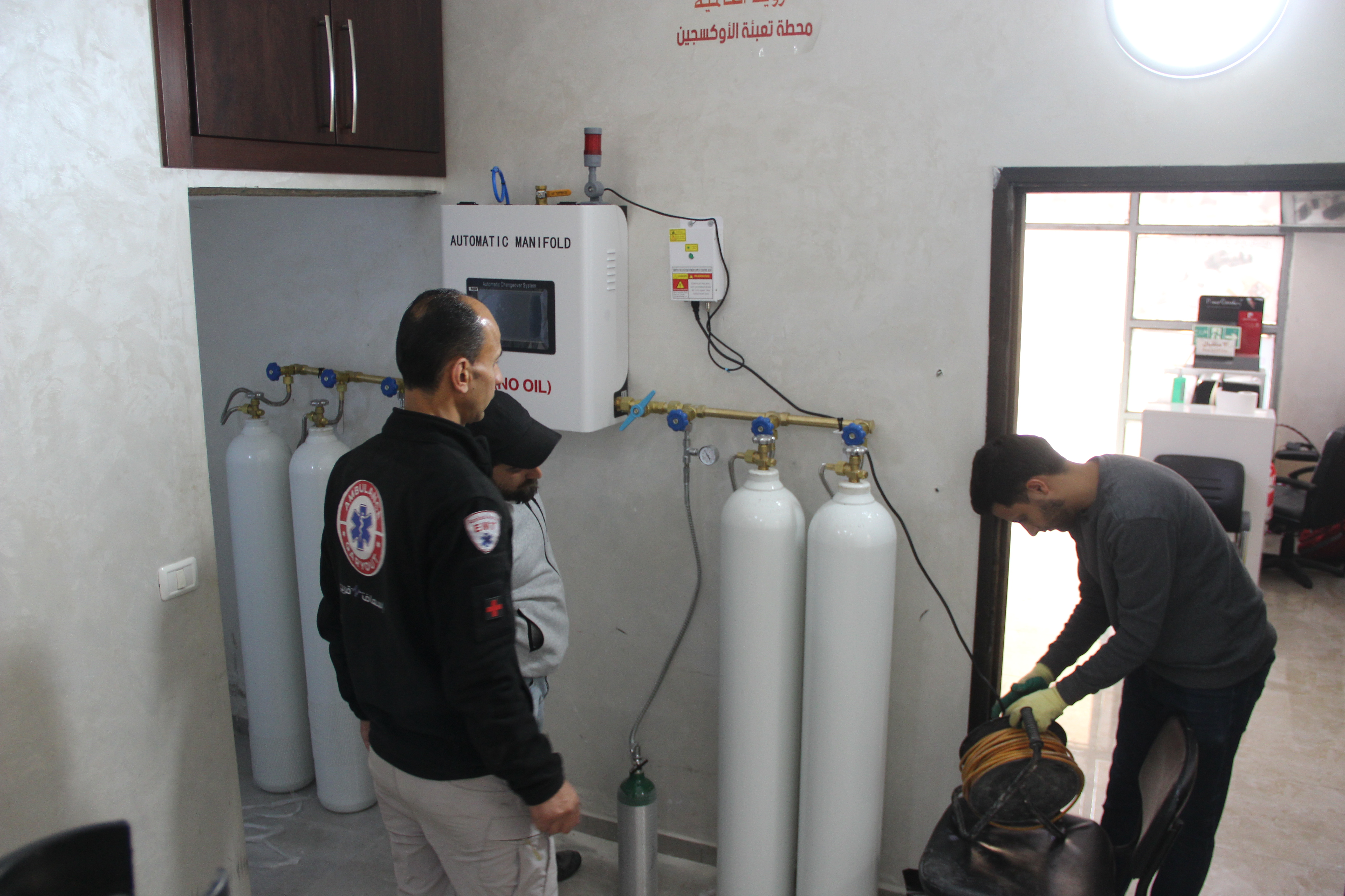 Engineers and emergency responders inspect and test the newly installed oxygen filling unit at the Palestine Red Crescent Society Emergency Centre in Qaryout, ensuring its readiness to provide uninterrupted oxygen supplies to patients and surrounding communities.  
