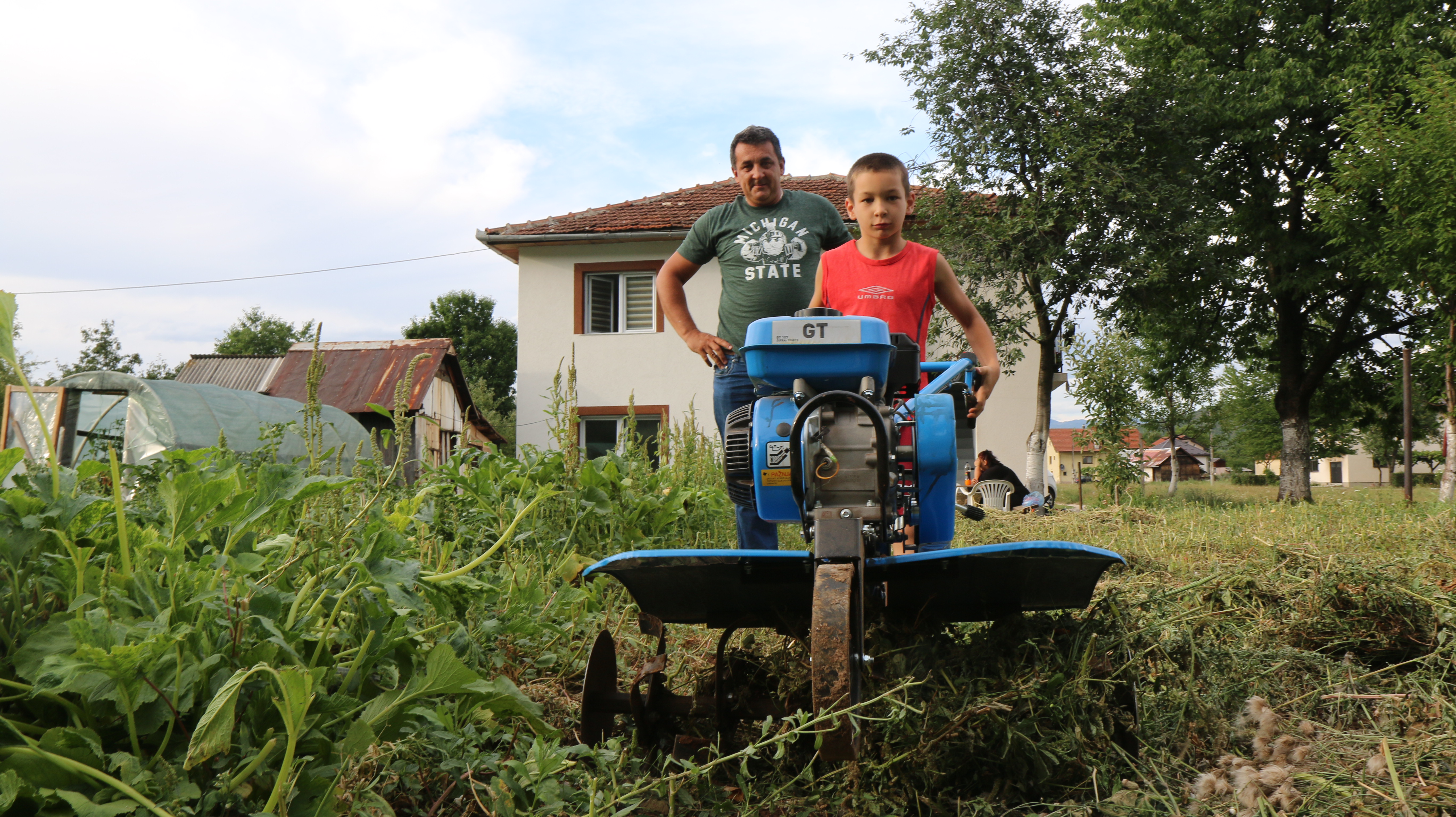 Uner his father's supervision, Vlado (8) starts the engine