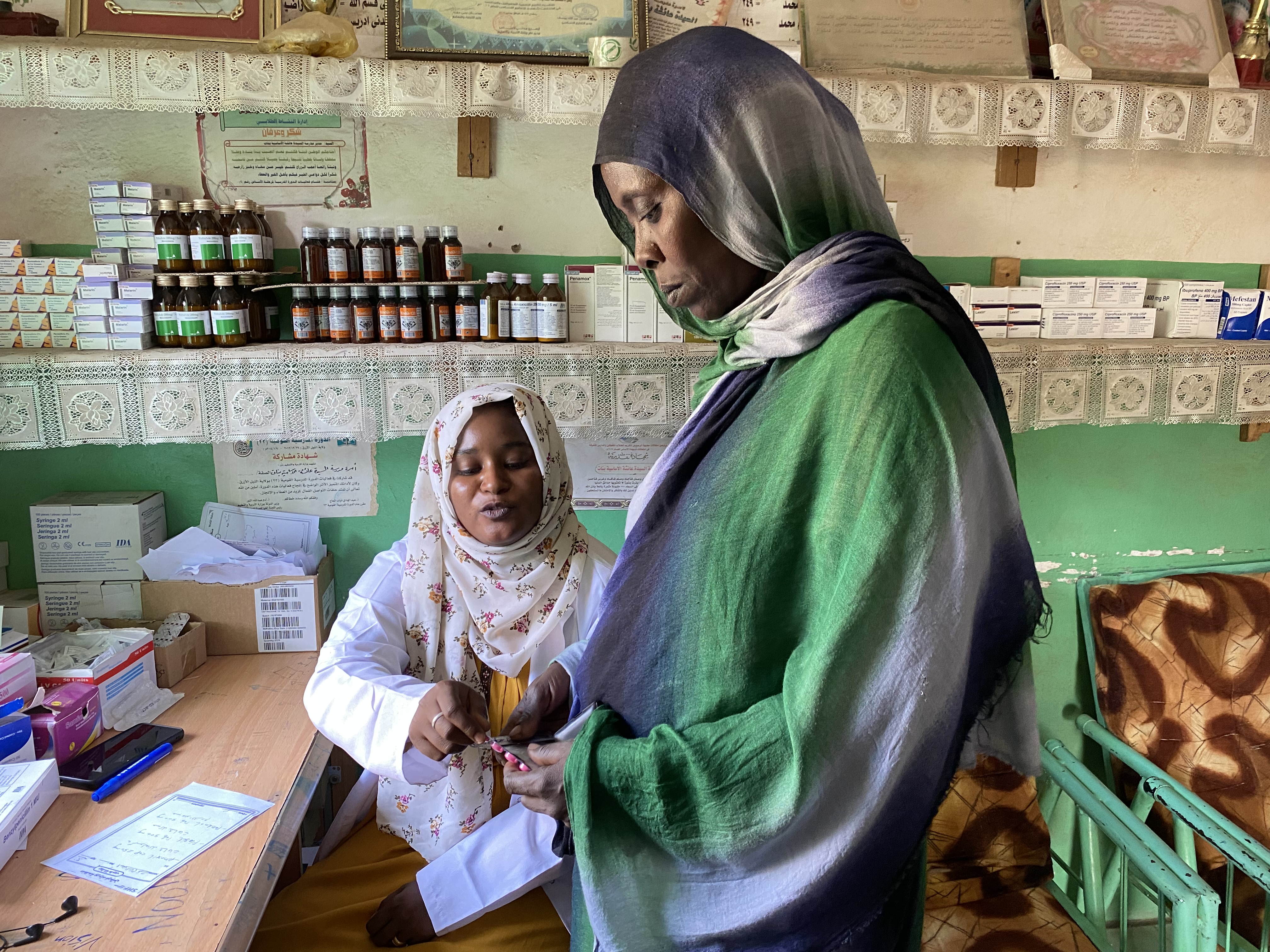 A woman receives medication from a health facility providing services to internally displaced people in Blue Nile Sudan