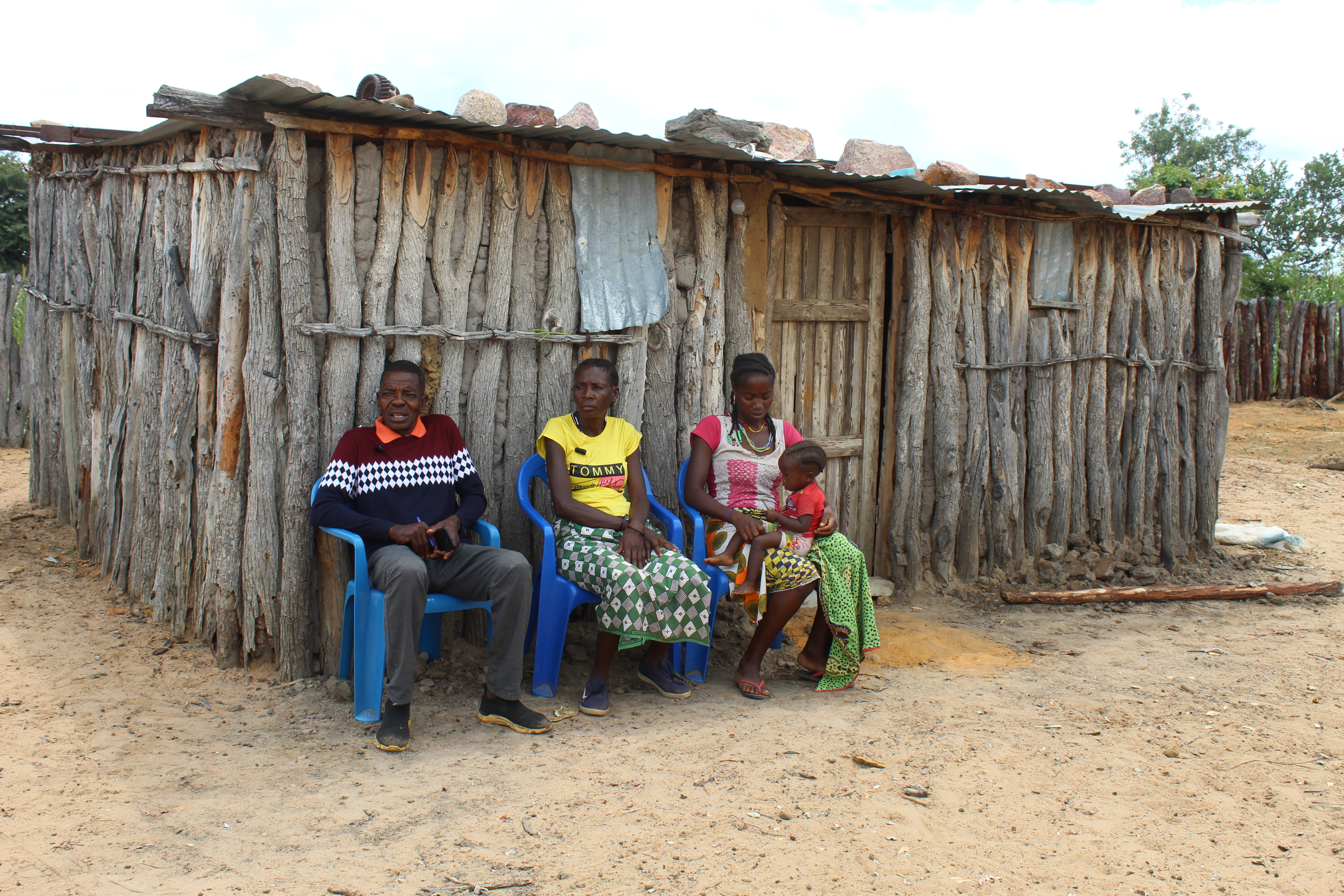 Joaquim with his wife, daughter, and grandson in front of one of his houses
