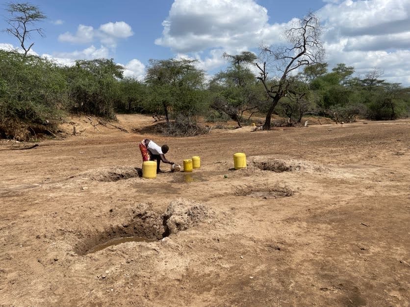 Some women in rural, drought-stricken areas in Kenya must dig into dry riverbeds to find water 