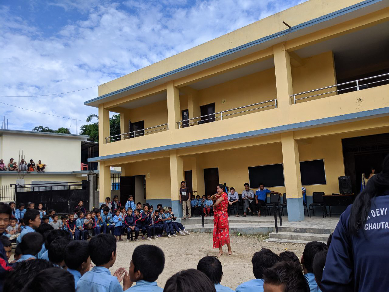 A girl student performs in the Teej programme