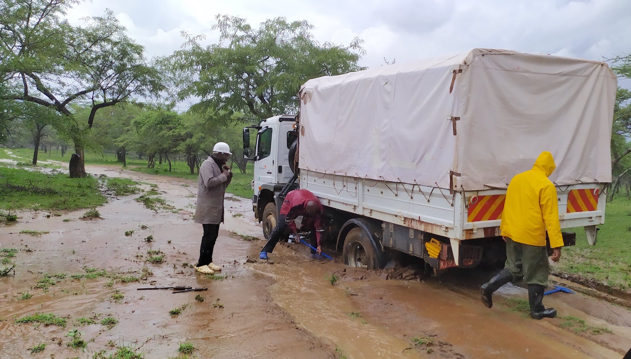 Heavy rainfall causes one of the trucks of the Kenya drilling to get stuck along the way.