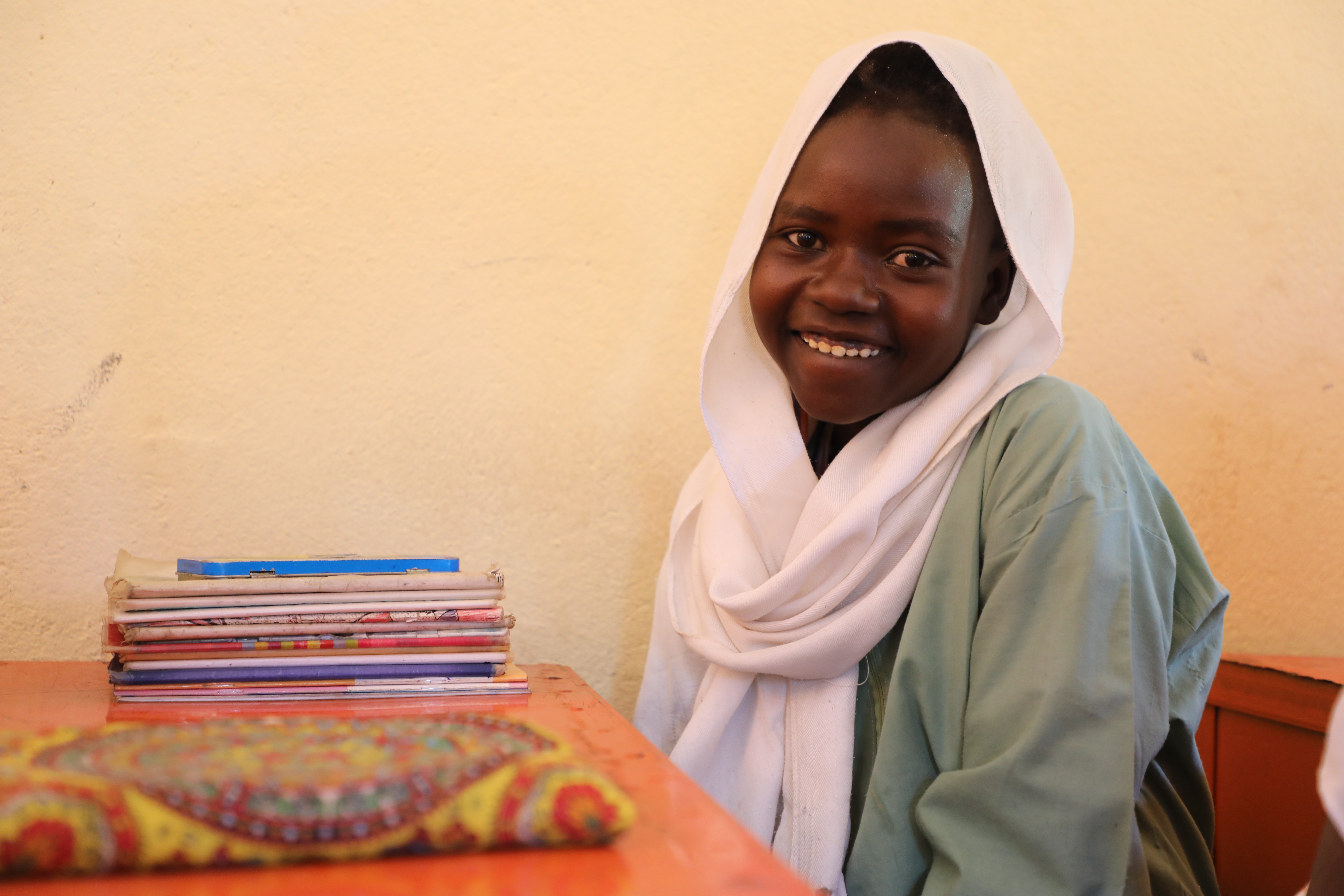 Smiling girl in a classroom renovated by World Vision Sudan