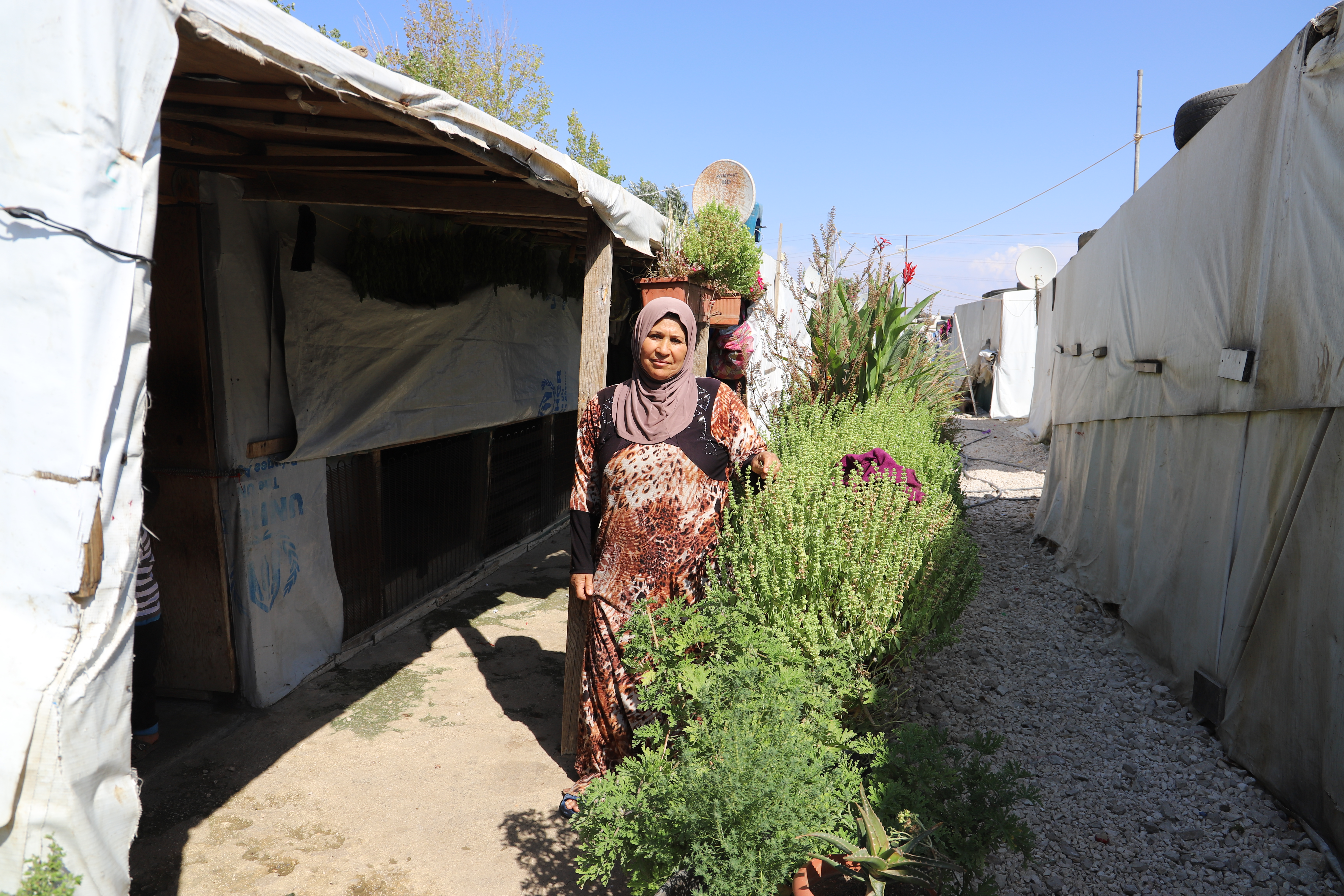 Mariam in front of her tent