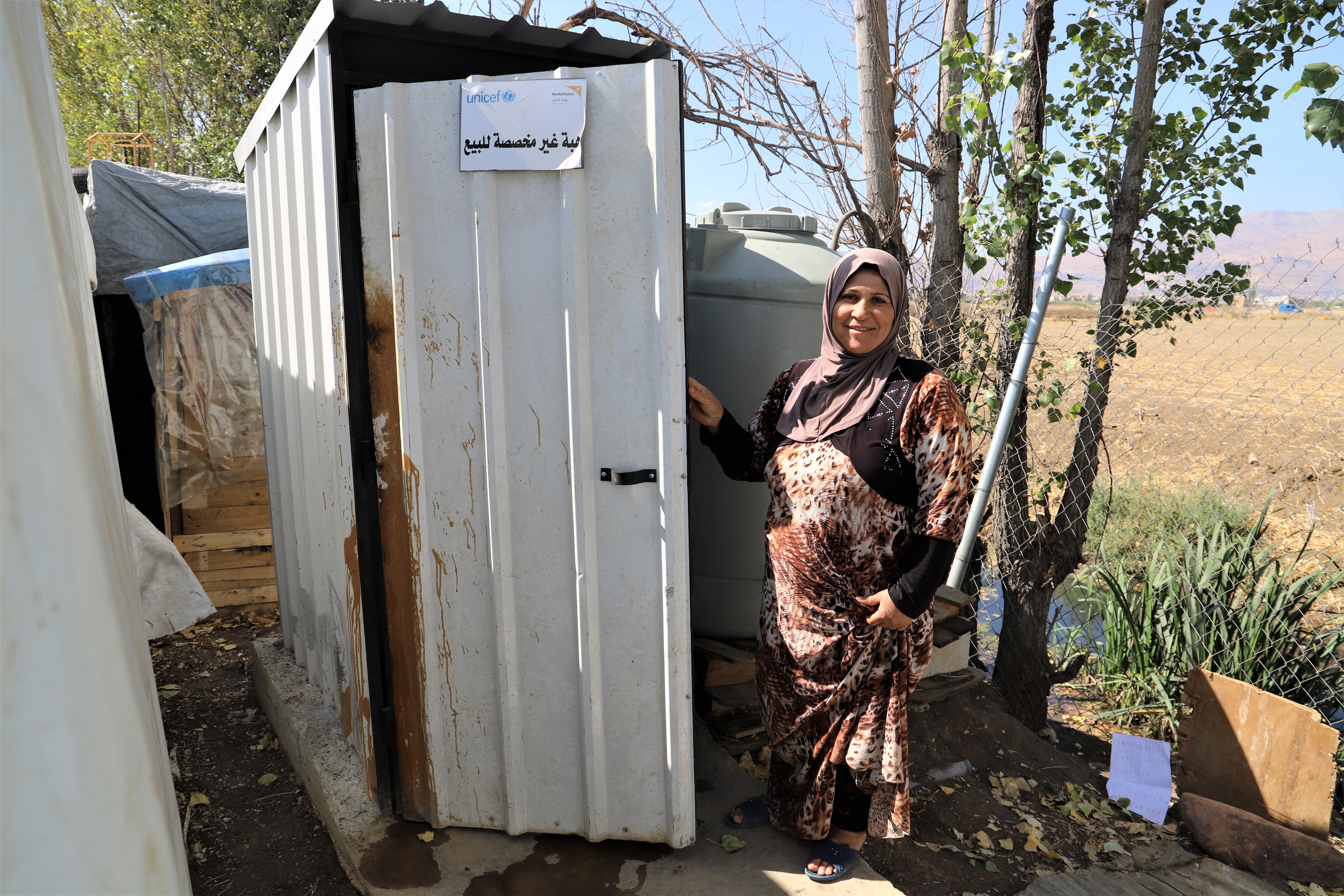 Mariam in front of the new latrine