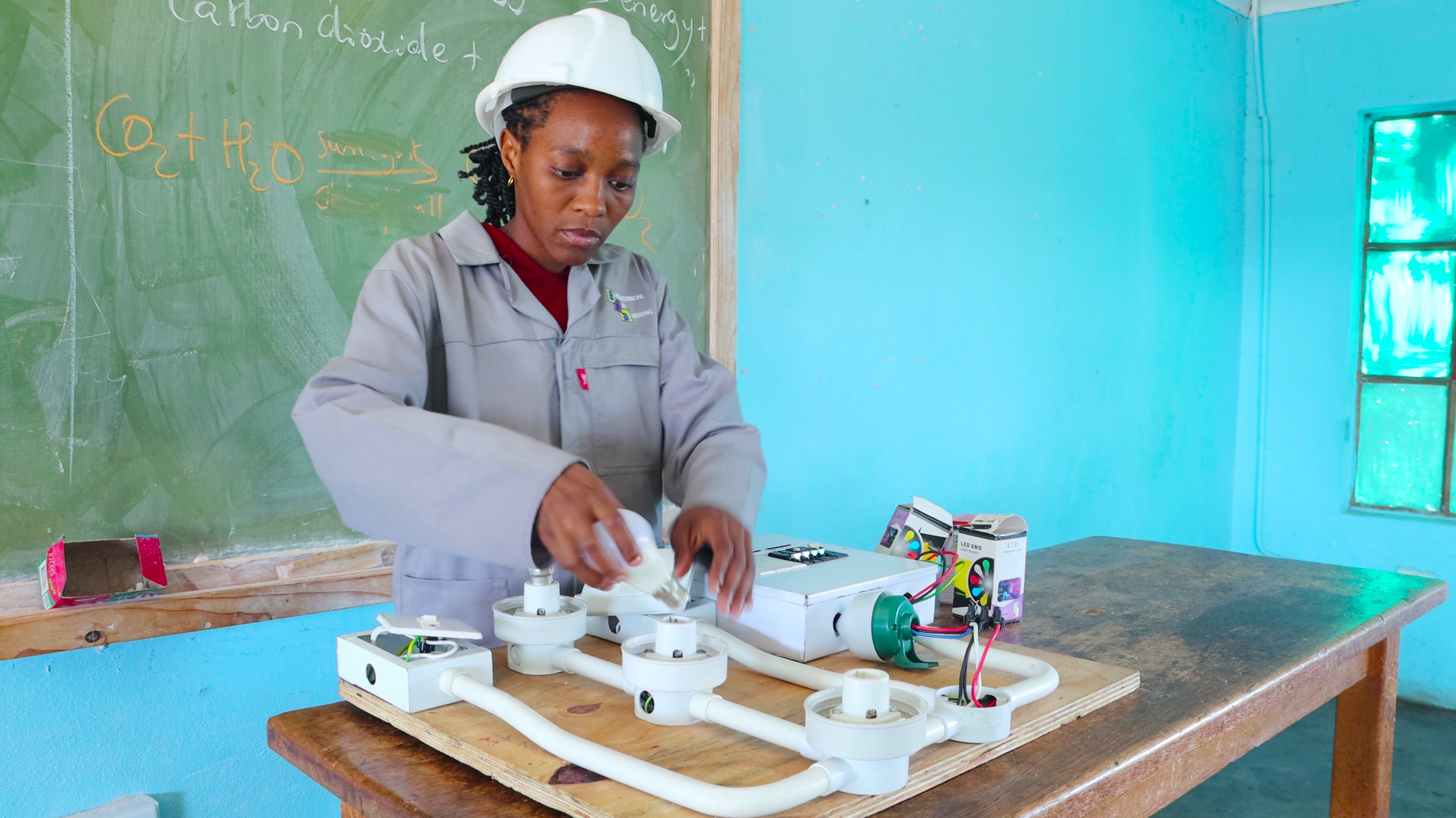 Nokwanda working on an electrical wiring model as part of her practicals.