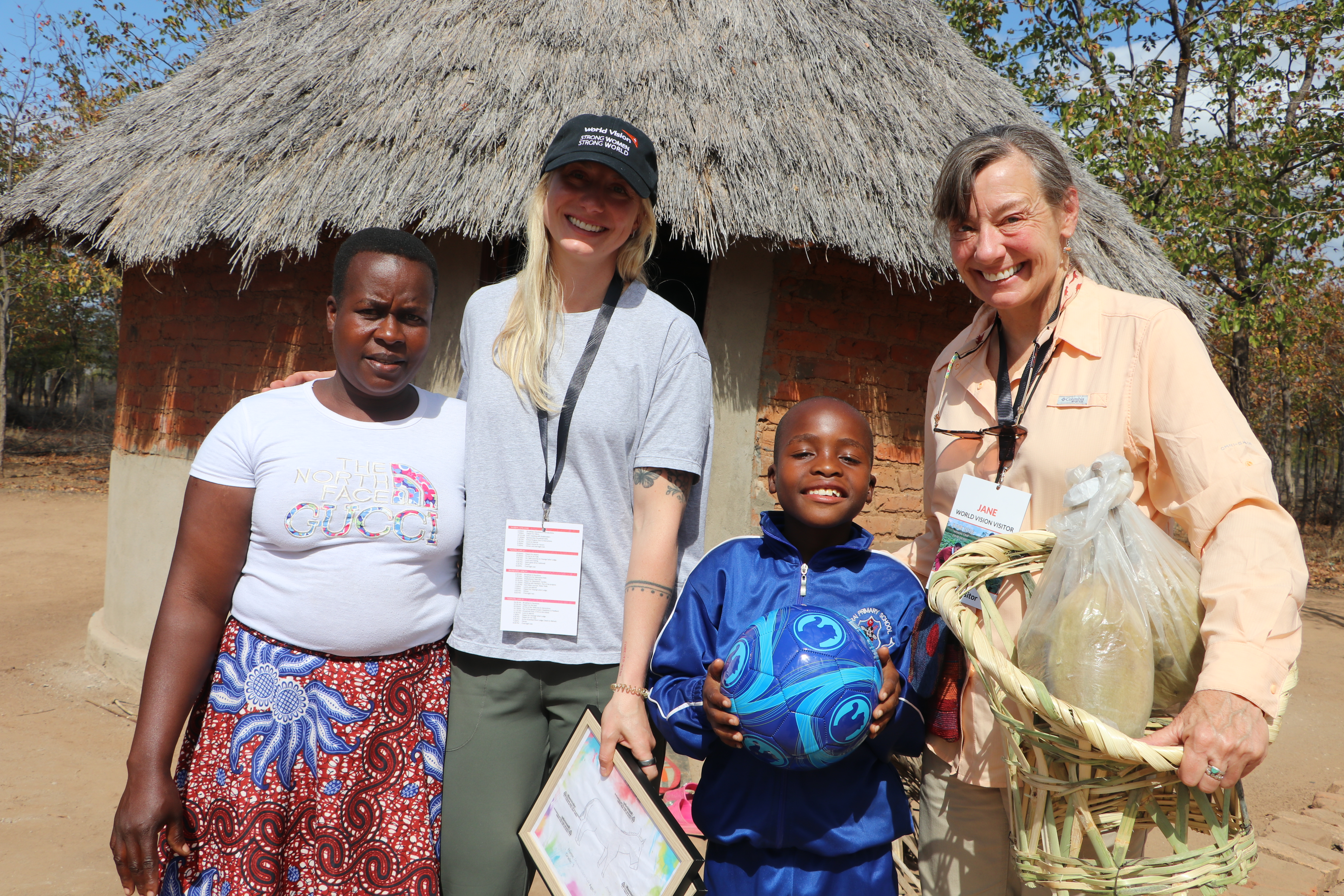 Members of the Presbyterian Church of Jackson Hall Jane (far right) and Hillary (black cap) spent time with their sponsored child Panashe and his family in Mbire