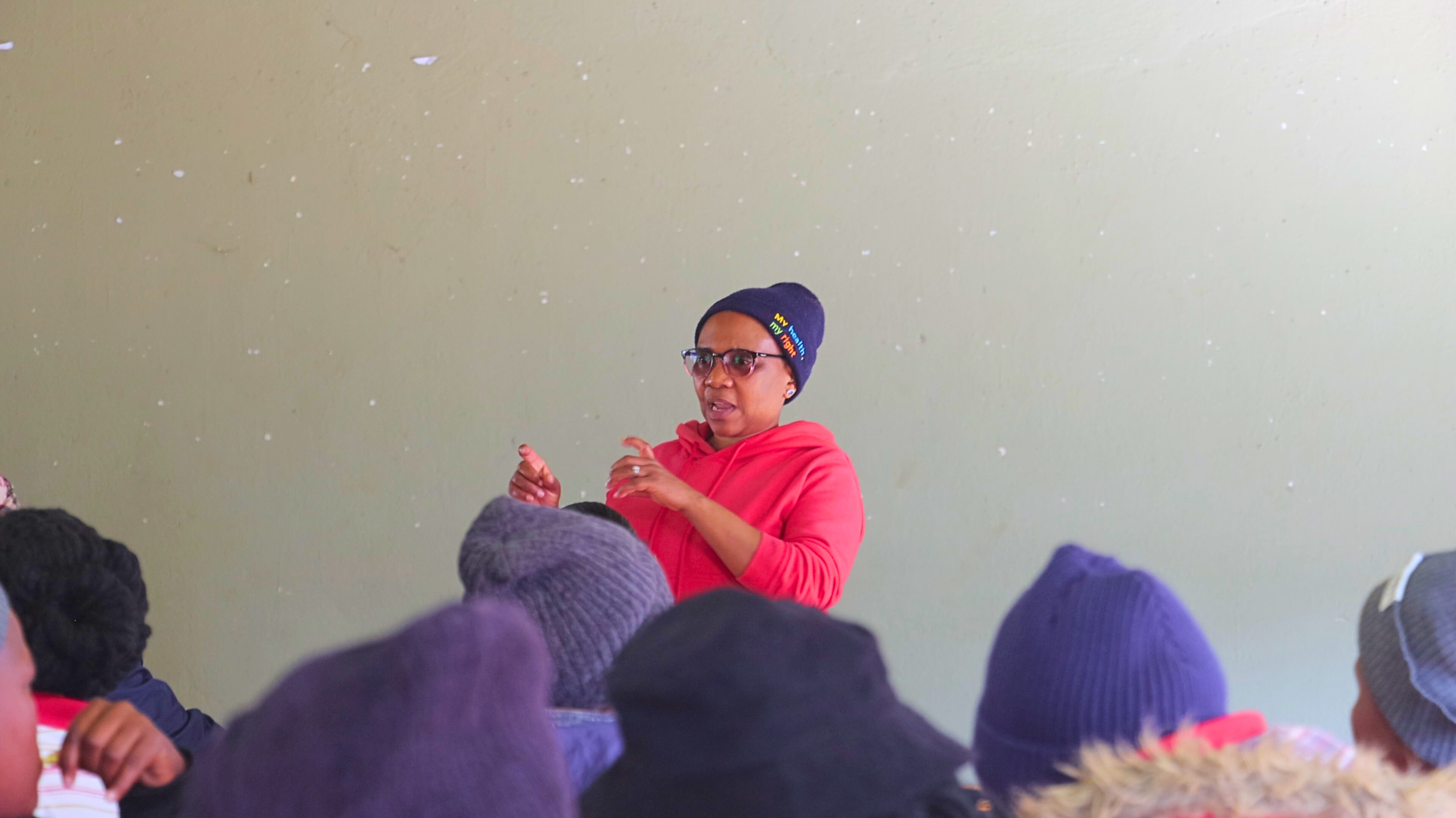 One of the facilitators of the training stressing a point while Rural Health Motivators listen attentively.