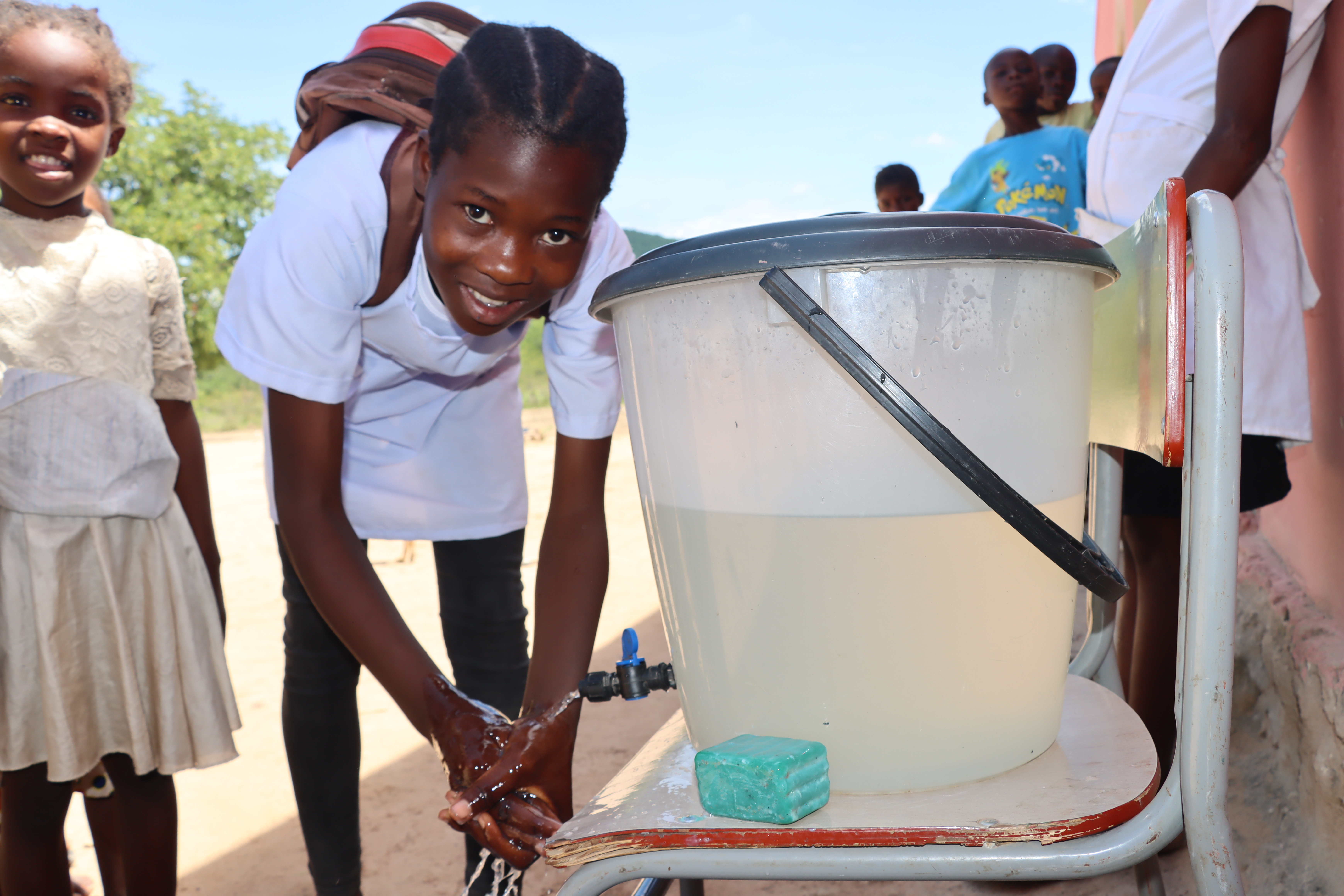 Isabel washing her hands before eating school lunch