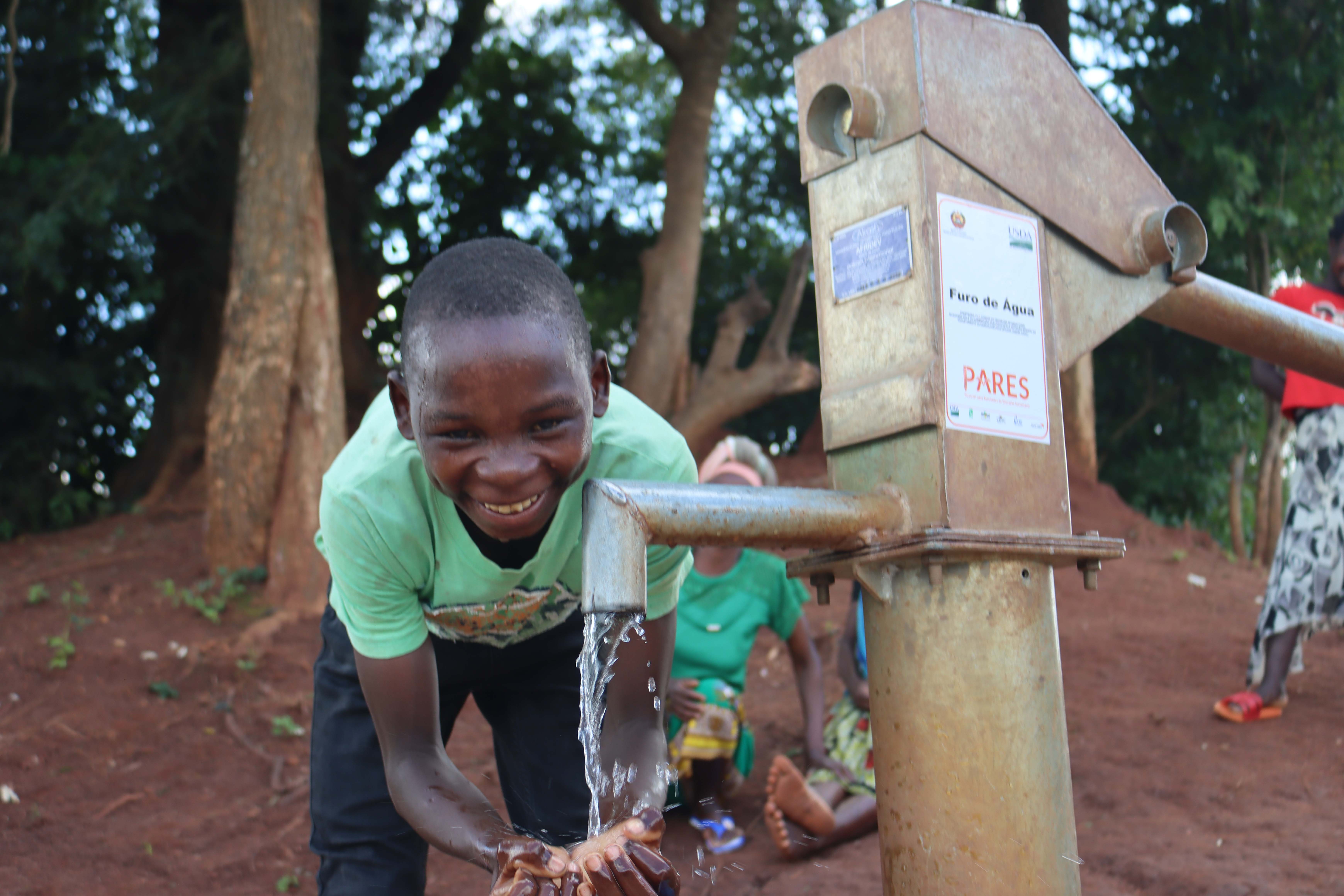 Samuel rejoices while drinking clean water from the new borehole 